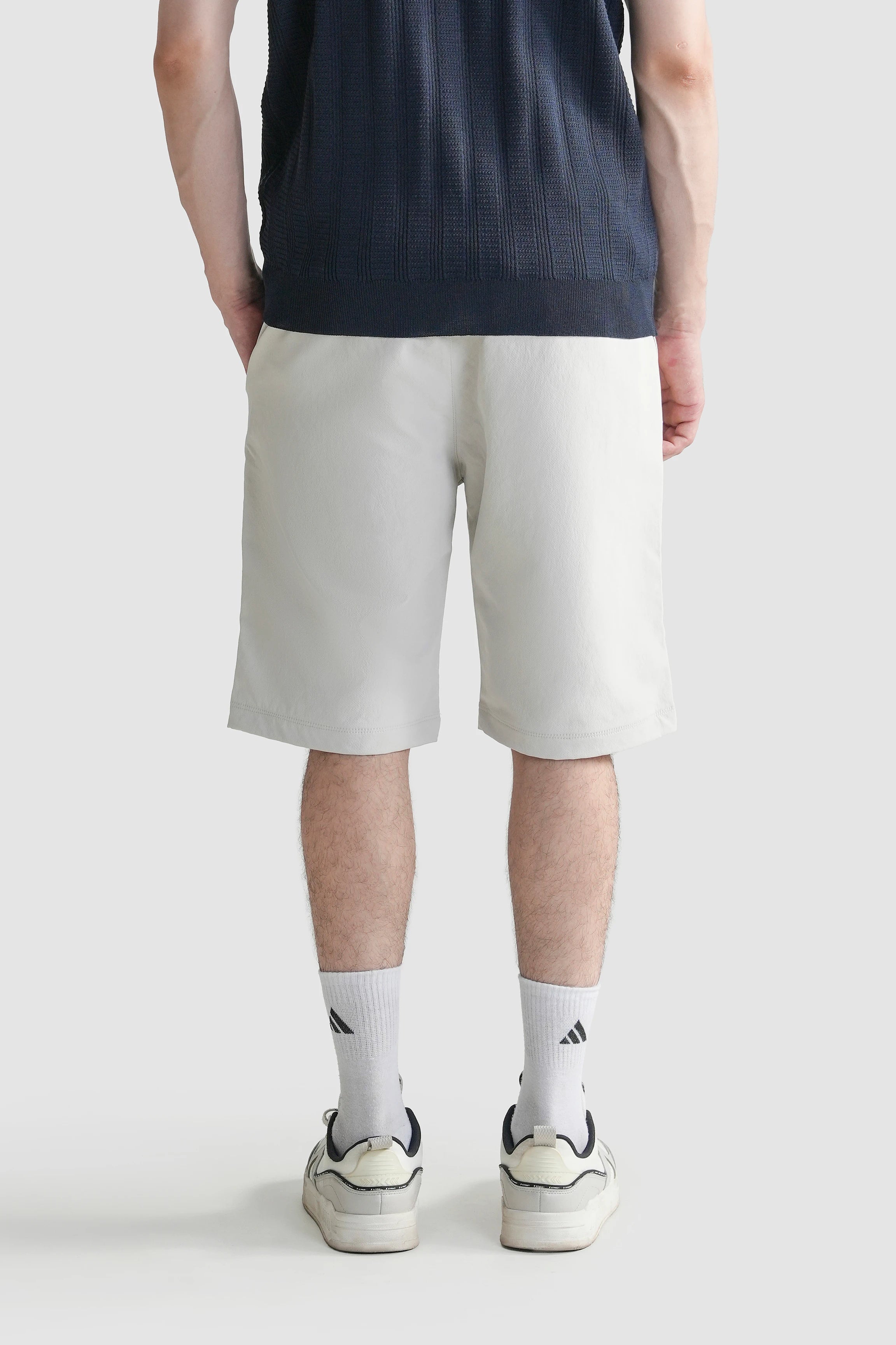 Regular-fit shorts in light color, back view with straight hem
