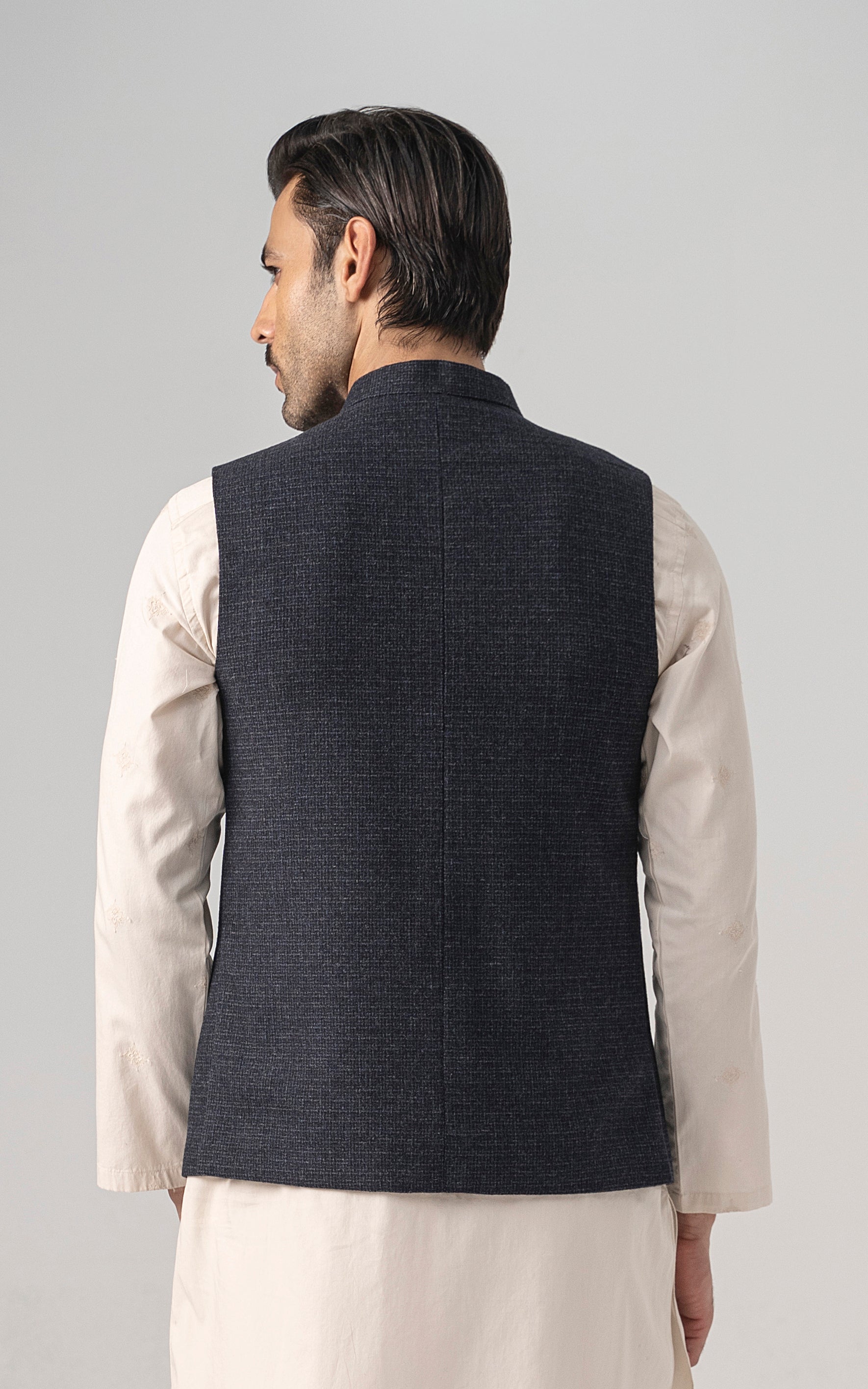 Navy textured waistcoat back view with standing collar and buttoned front edge