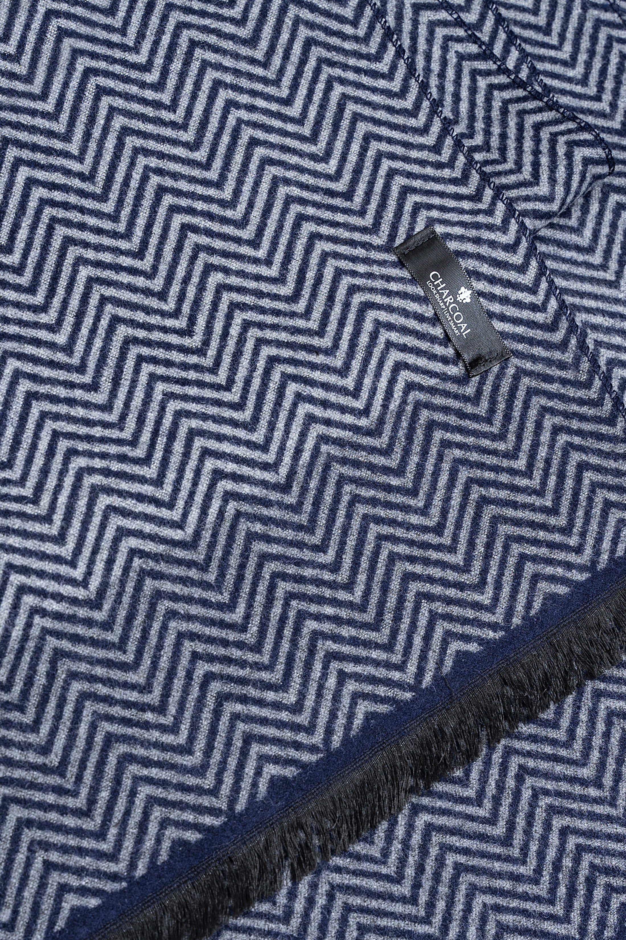 Dark blue zigzag scarf close-up with fringed edge and brand tag label
