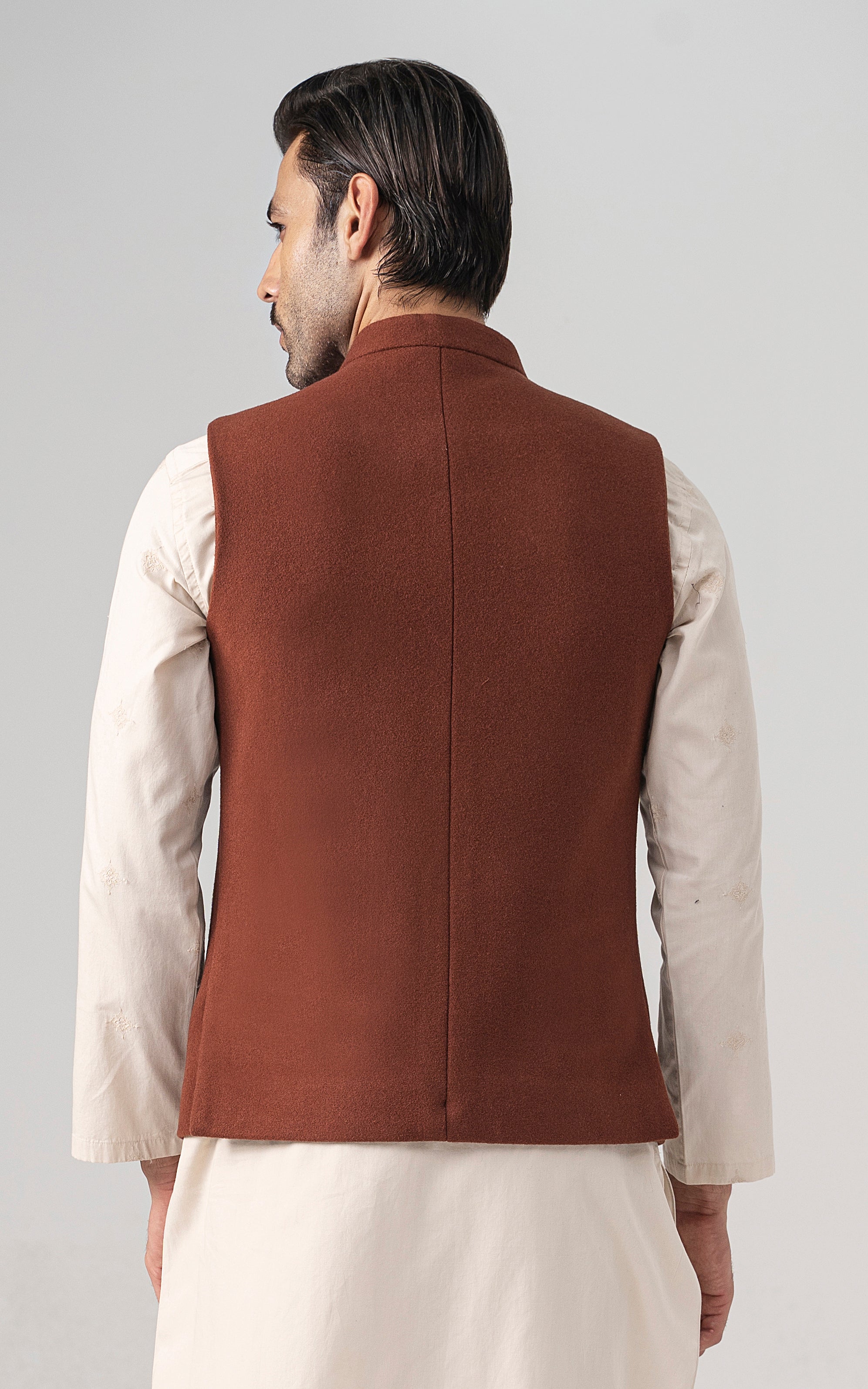 Rust wool-blend waistcoat back view with centered seam and smooth panel