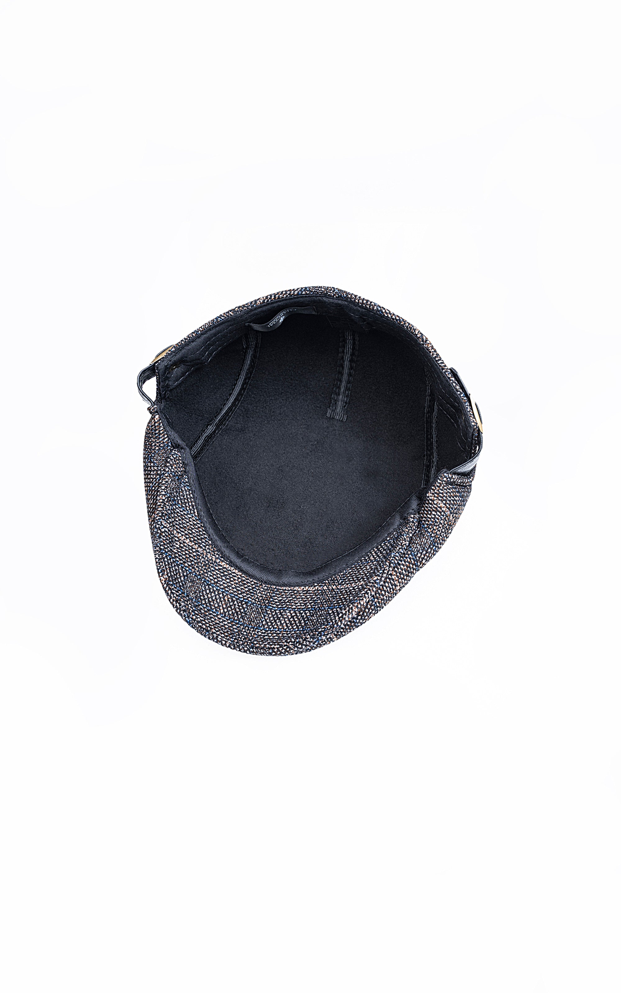 Golf cap interior view with navy lining and stitched crown seams, brim edge visible.