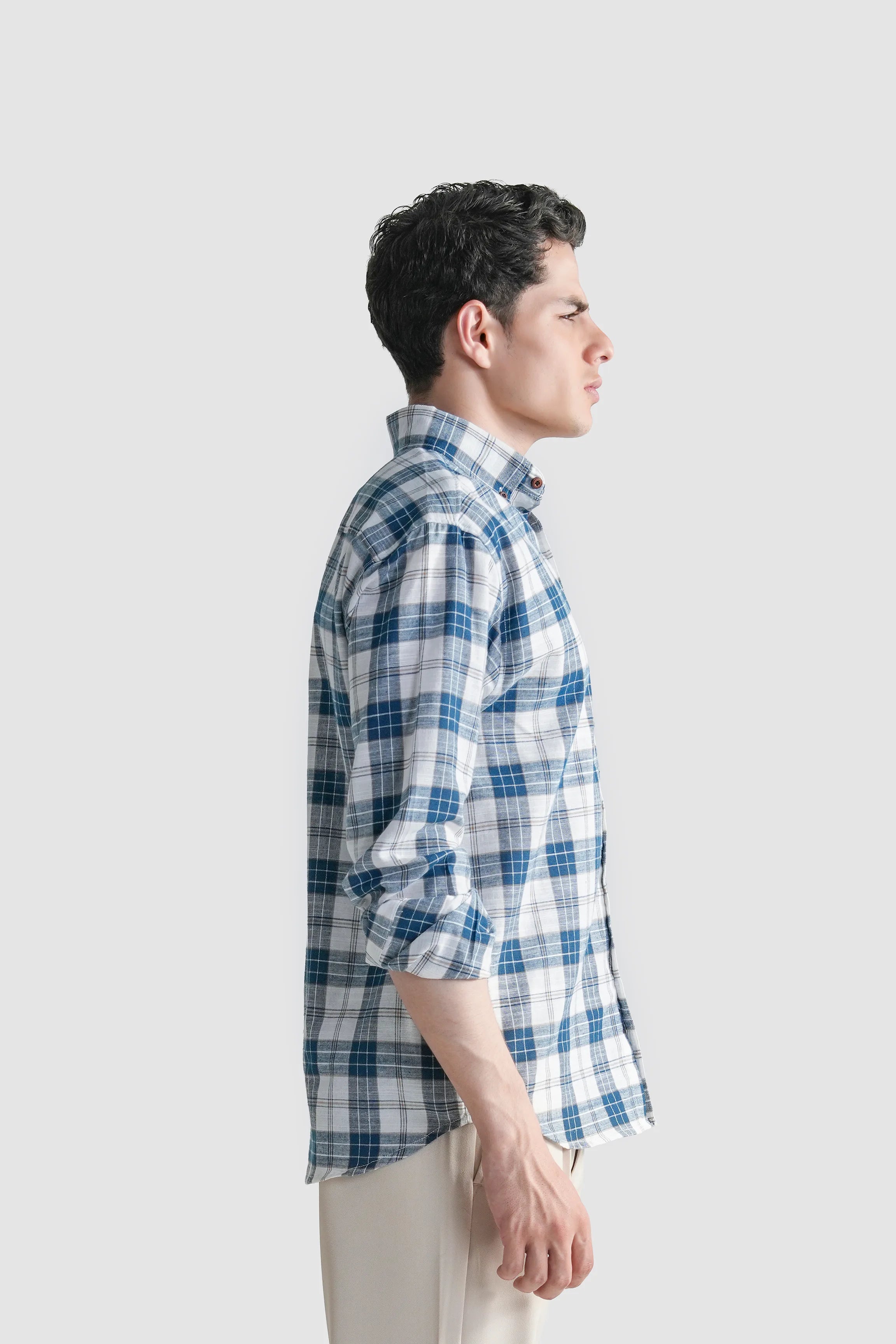 Blue and white plaid button-up shirt on model, side view, long sleeves