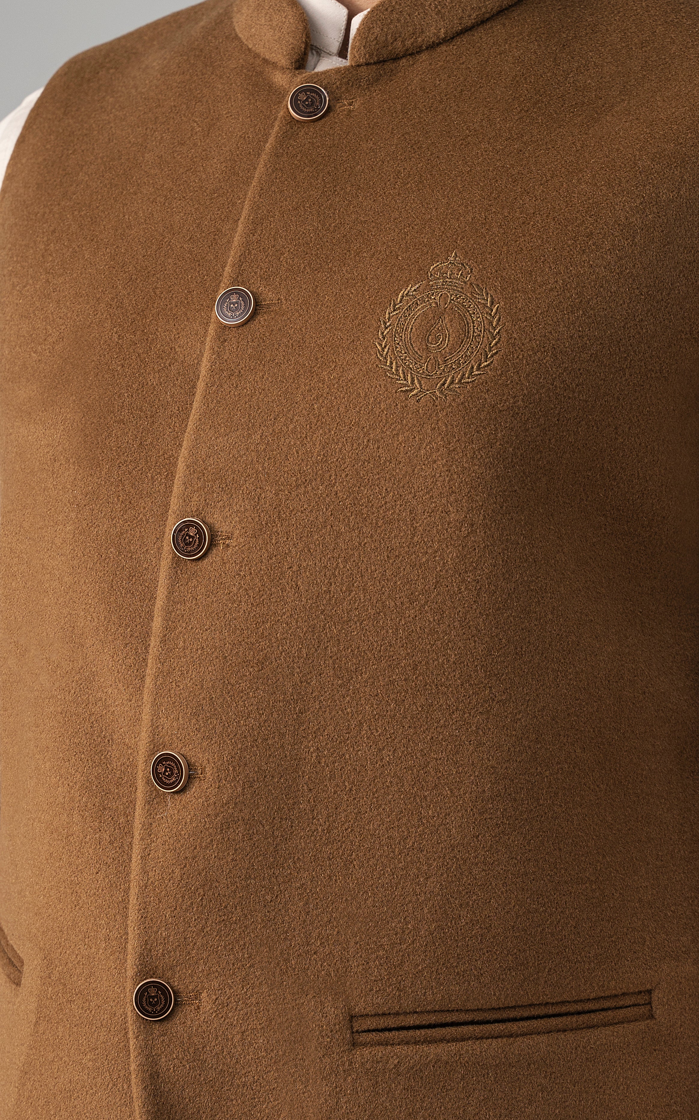 Wool-blend waistcoat close-up with round buttons and embroidered chest crest