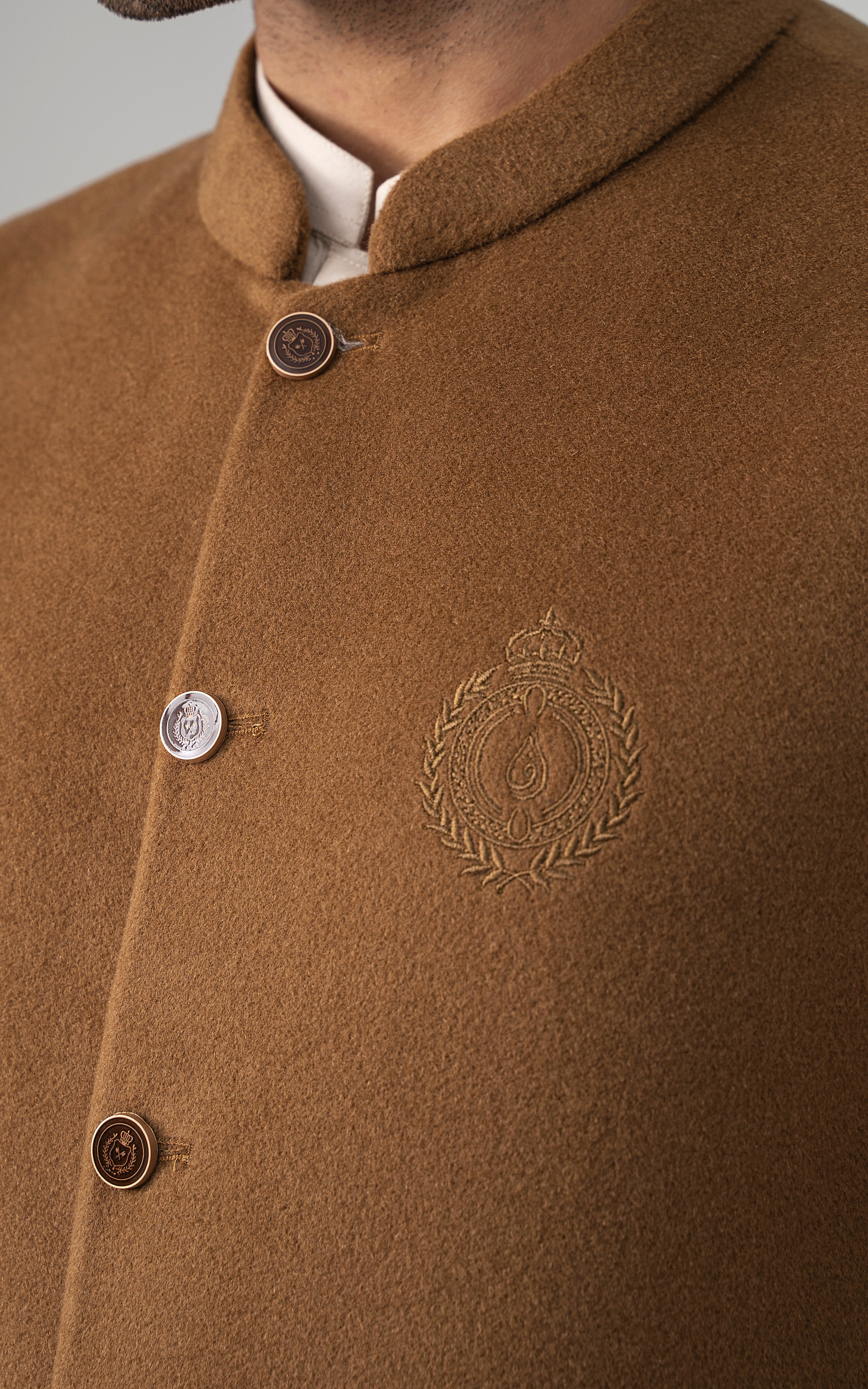 Wool-blend waistcoat collar close-up with buttons and embroidered crest