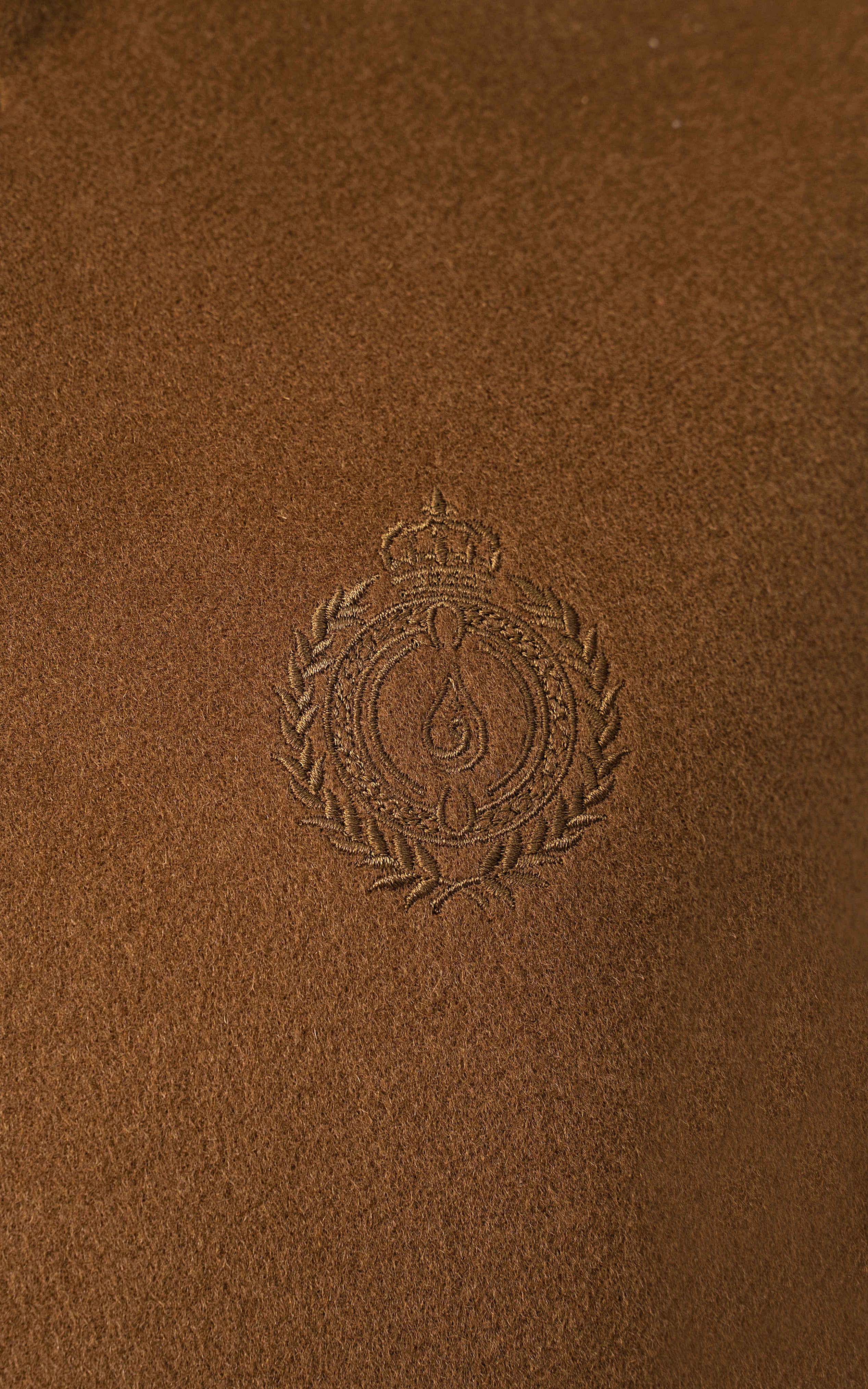 Embroidered crest on wool-blend waistcoat fabric