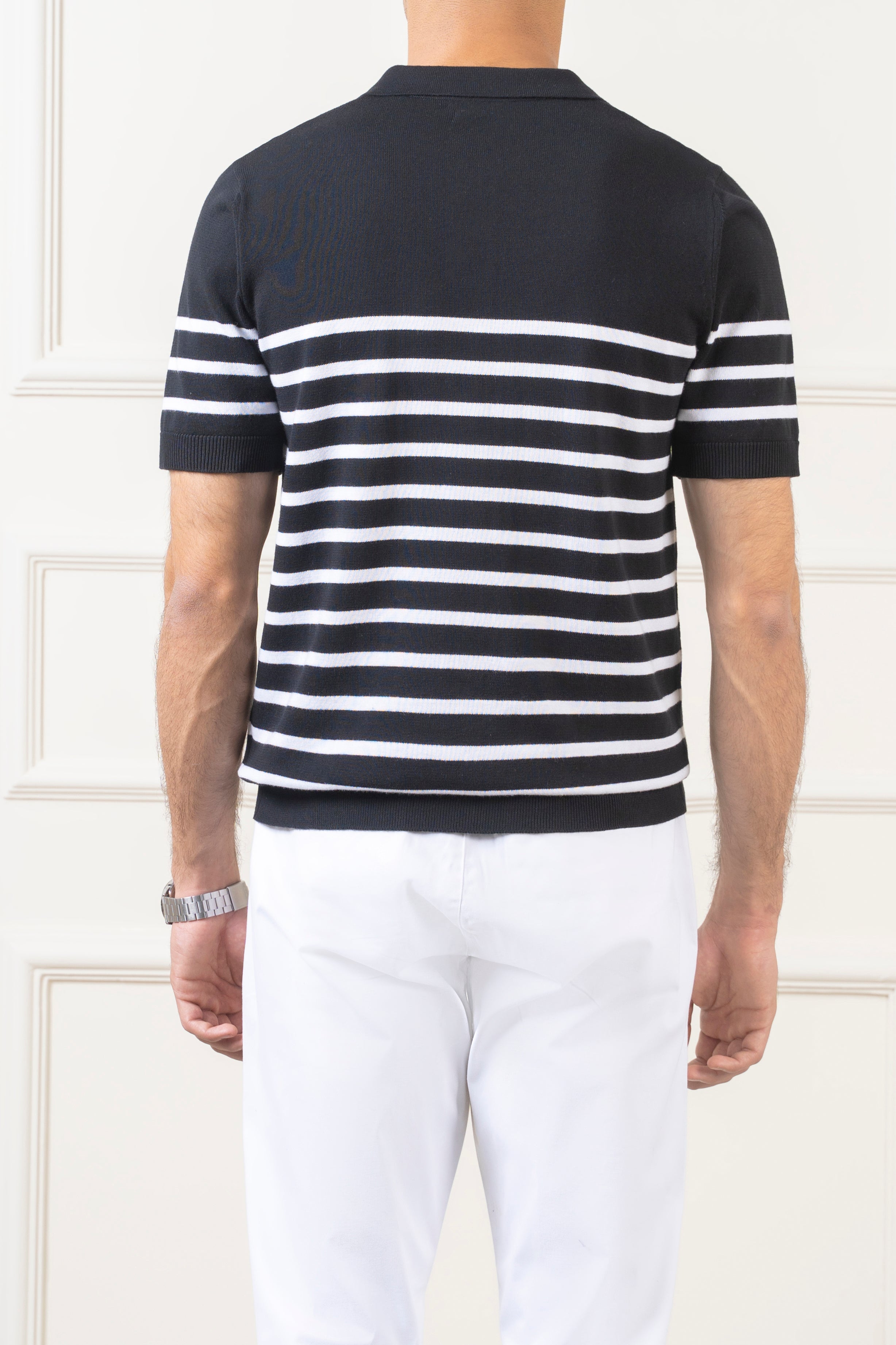 Men's knit polo sweater back view in black with white horizontal stripes.