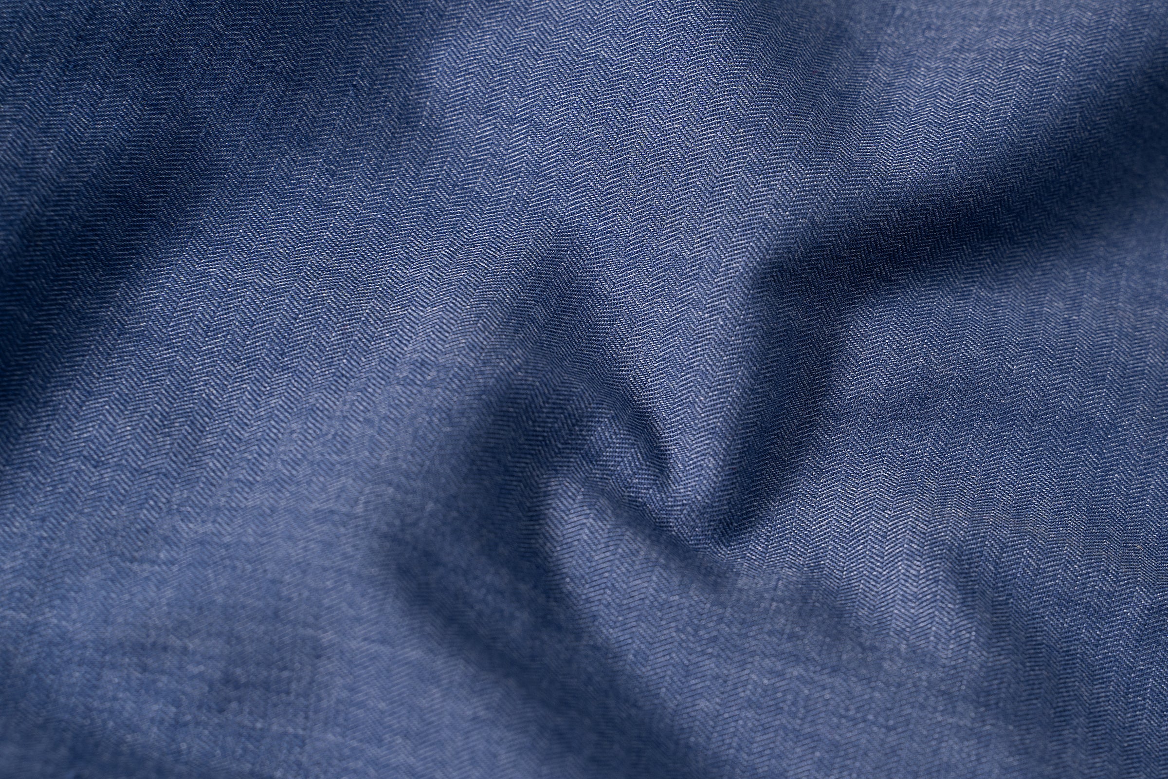 Blue shirt fabric close-up with subtle texture