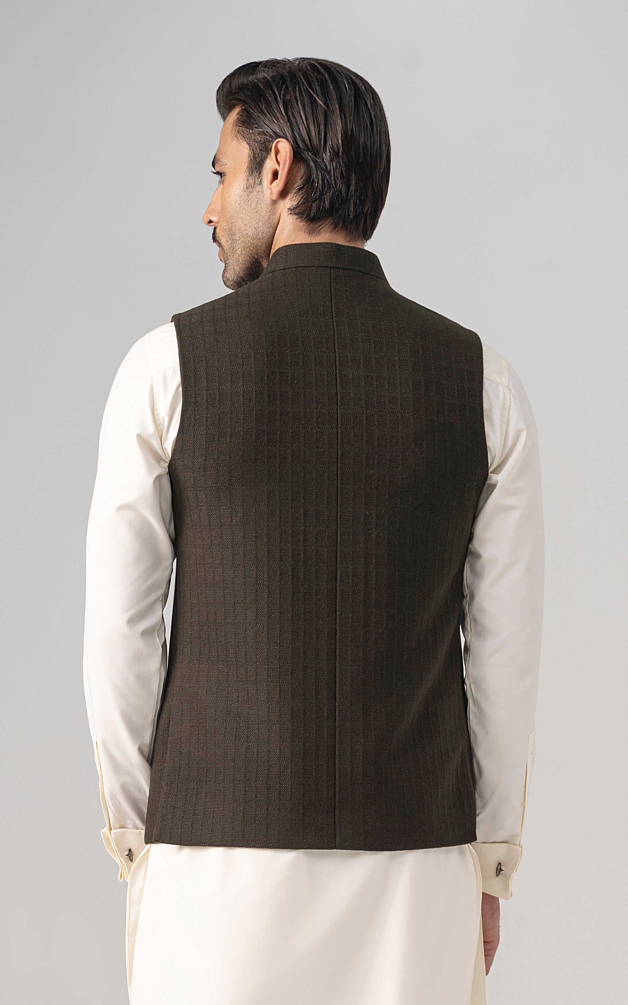 Back of dark olive textured waistcoat with button placket and stand collar