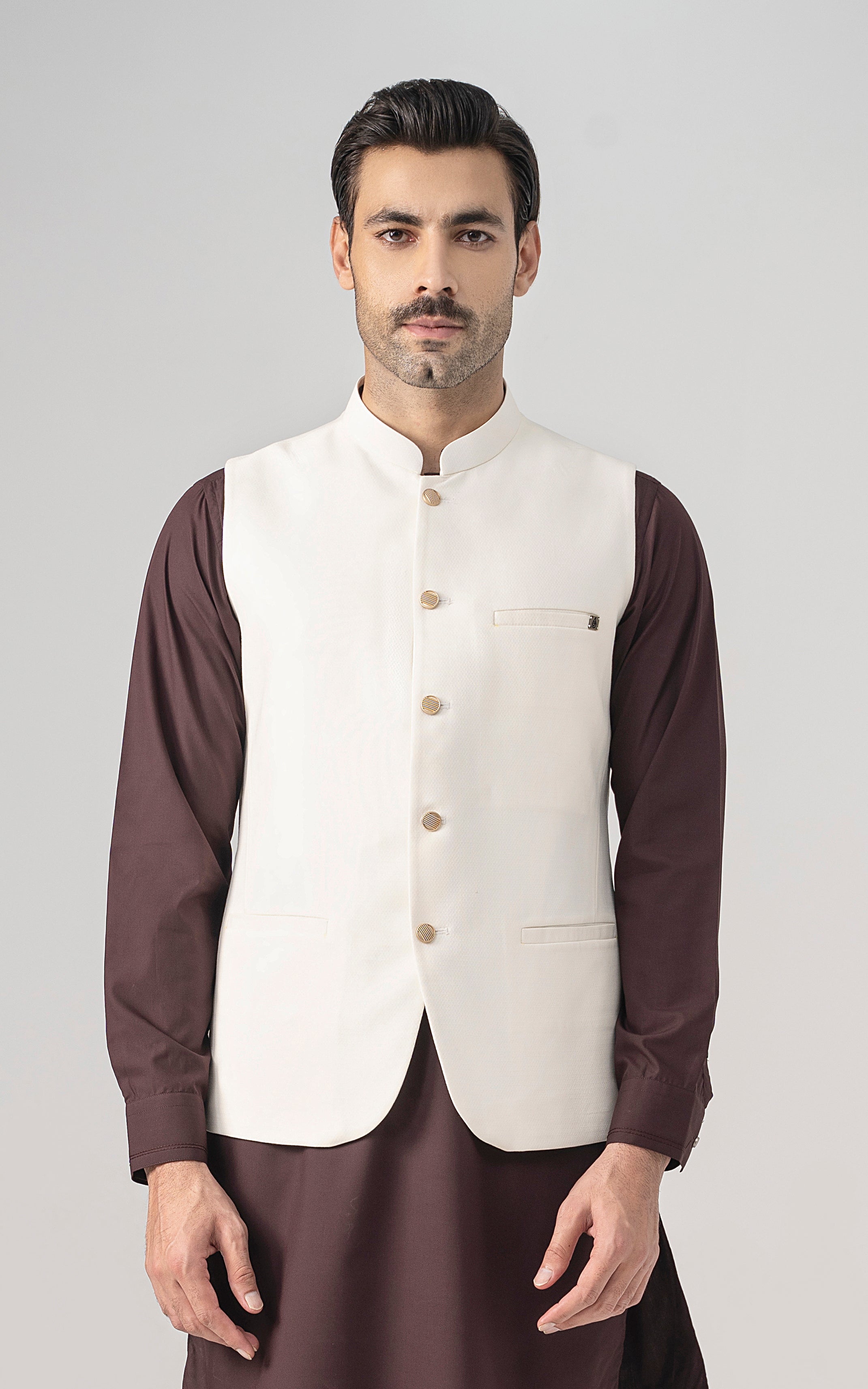 Off-white textured waistcoat with stand collar, front buttons, and chest pocket.