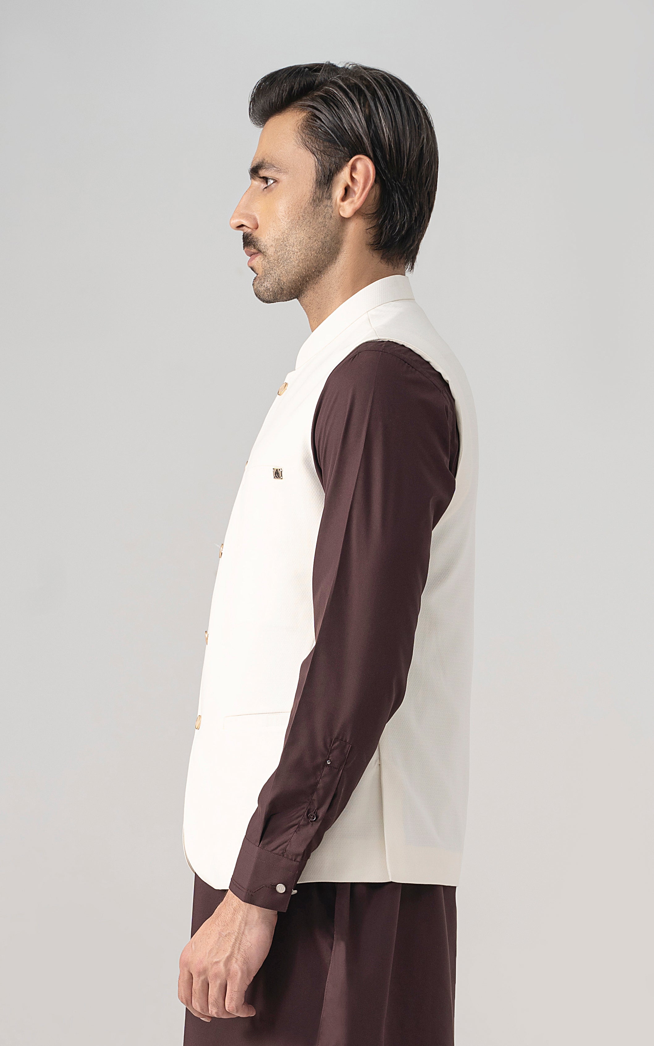 Off-white textured waistcoat with stand collar and front buttons, side view.