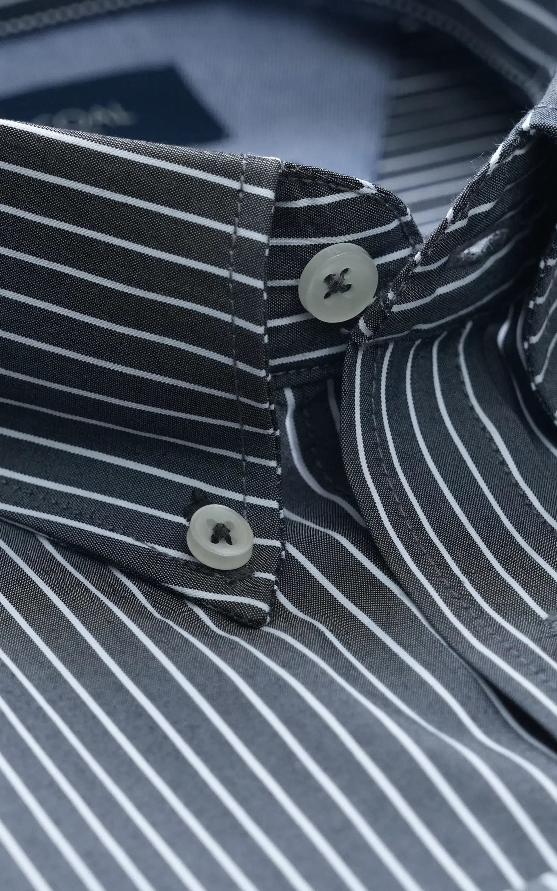 Dark grey striped dress shirt collar with two buttons and curved placket