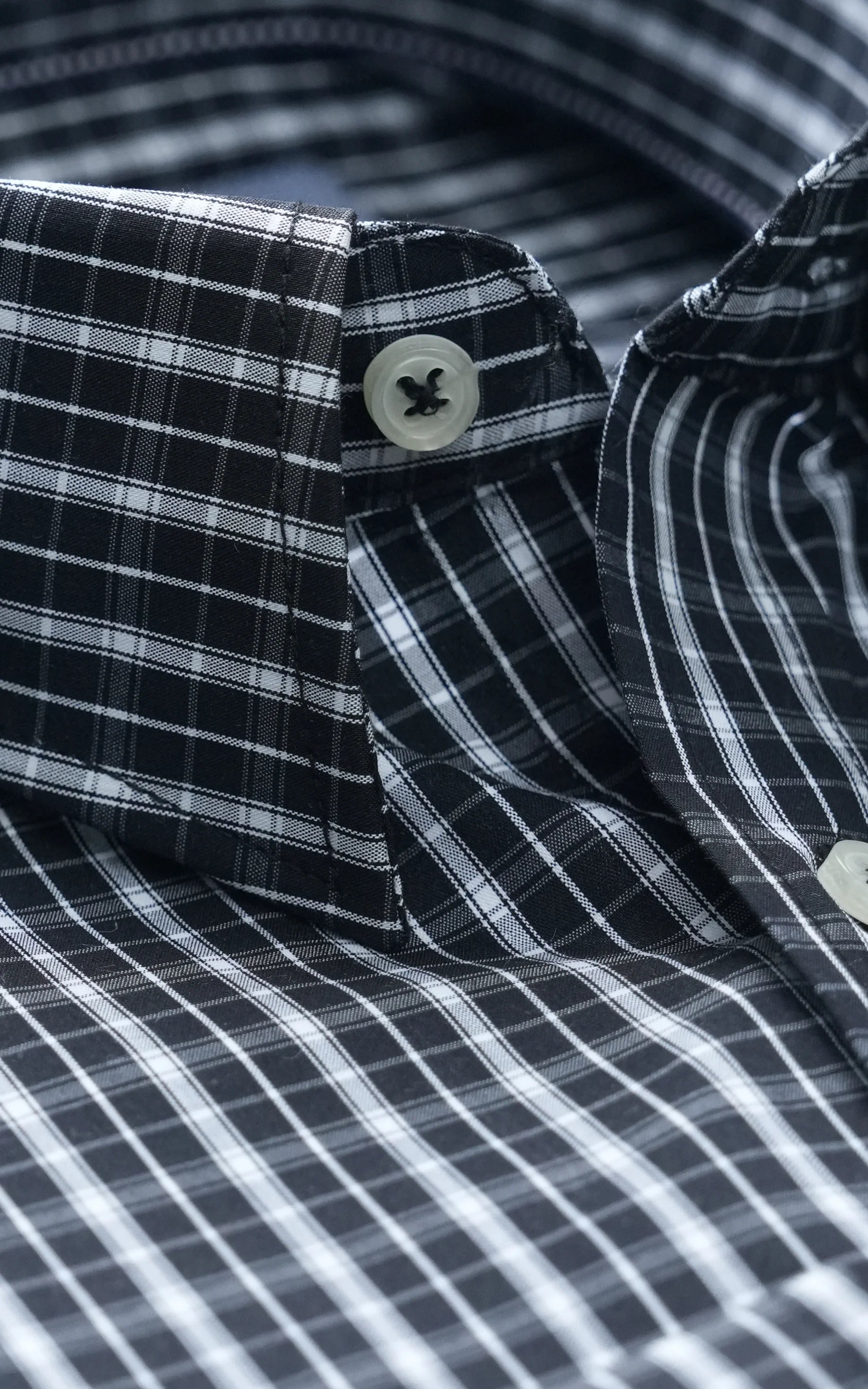 Black check dress shirt close-up, button and collar tips