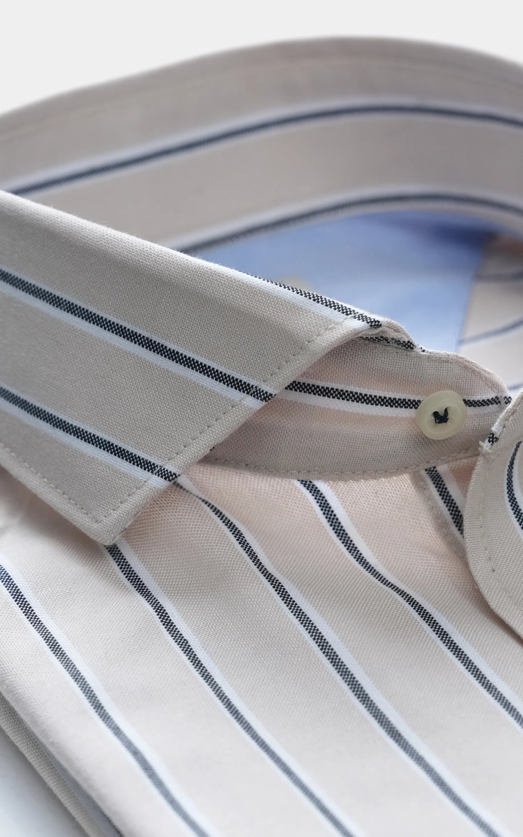 French-collar striped shirt close-up, cream with navy lines and button placket