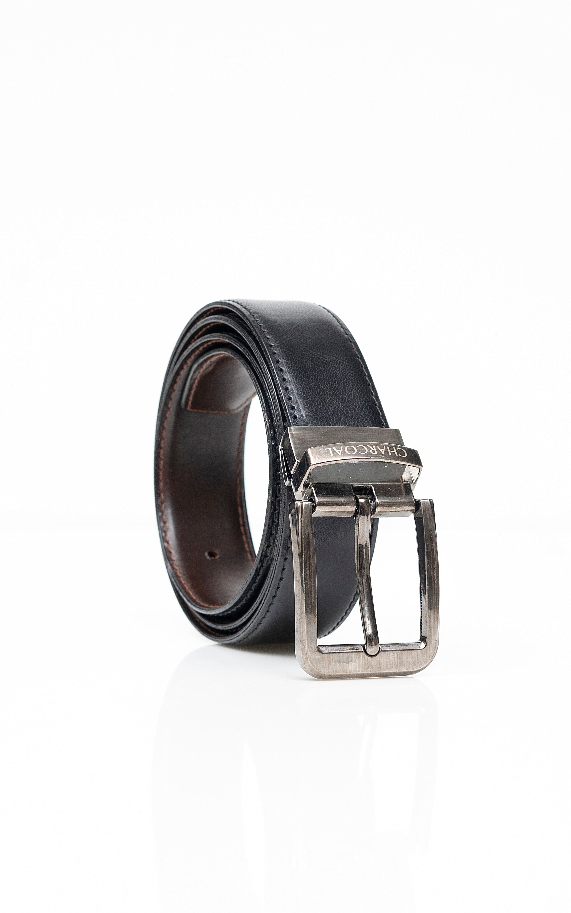 Reversible belt close-up with dark and brown leather sides and silver metal buckle.