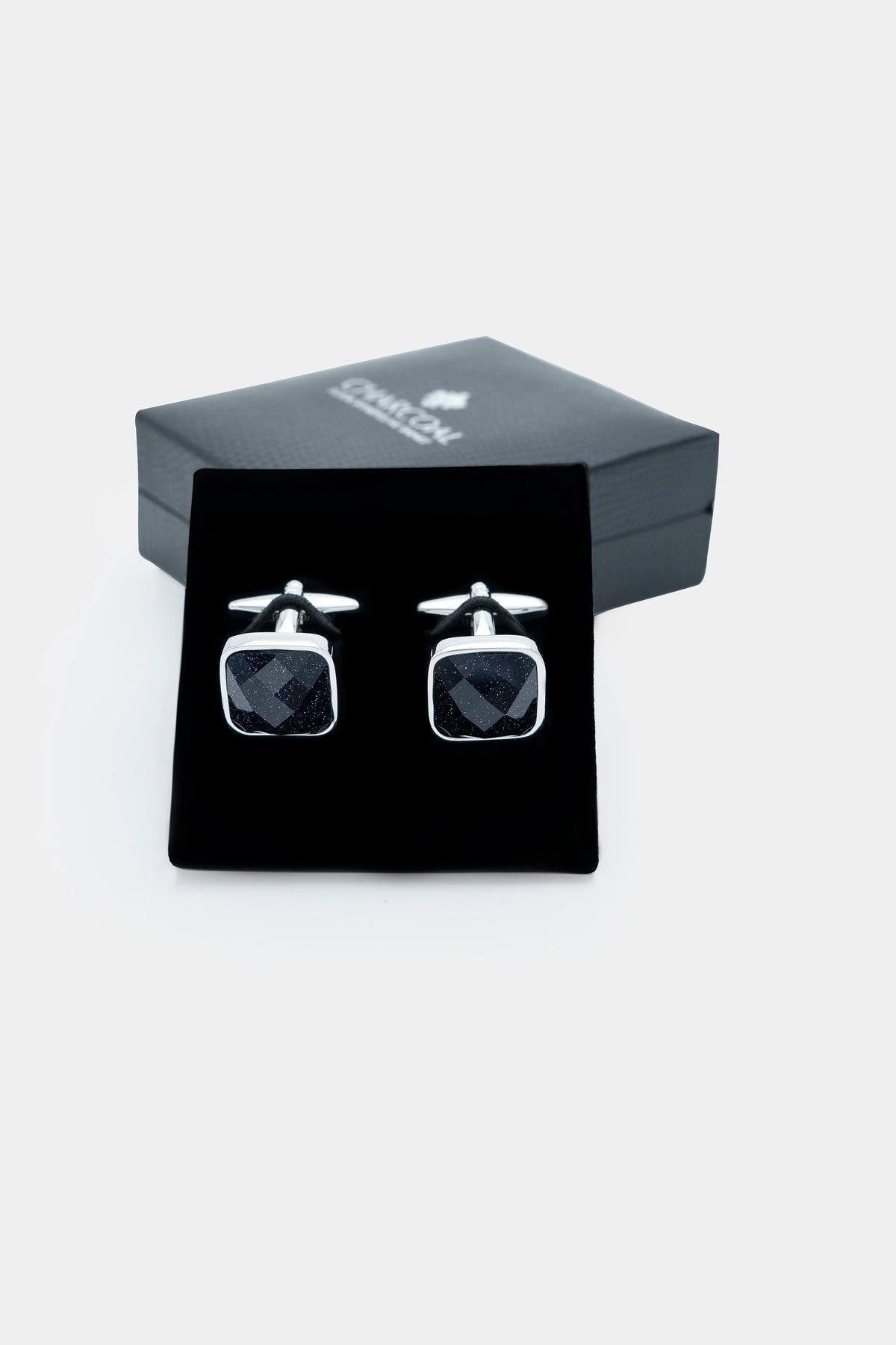 Cufflinks in gift box with square dark stone faces and silver posts