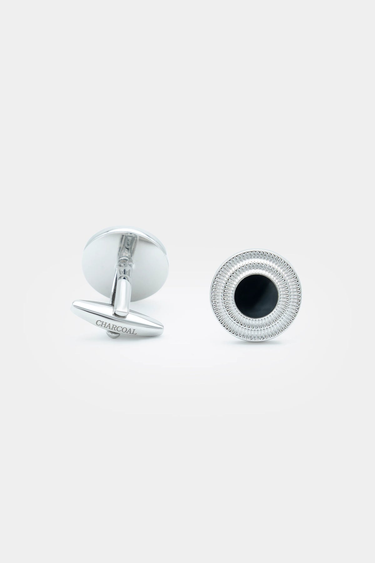 Silver round textured cufflinks with dark centers, stud post visible