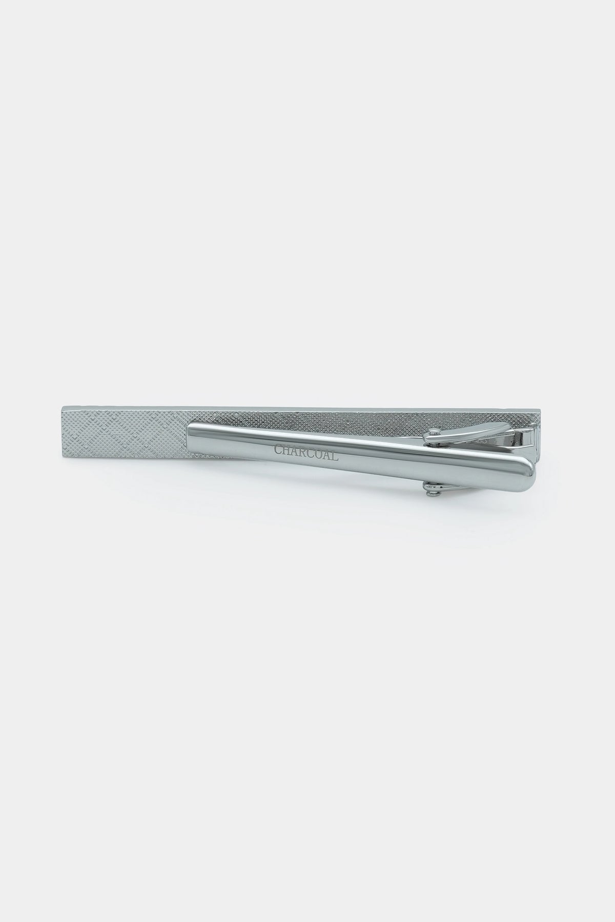 Silver tie pin with side clasp shown on a textured card-style display panel