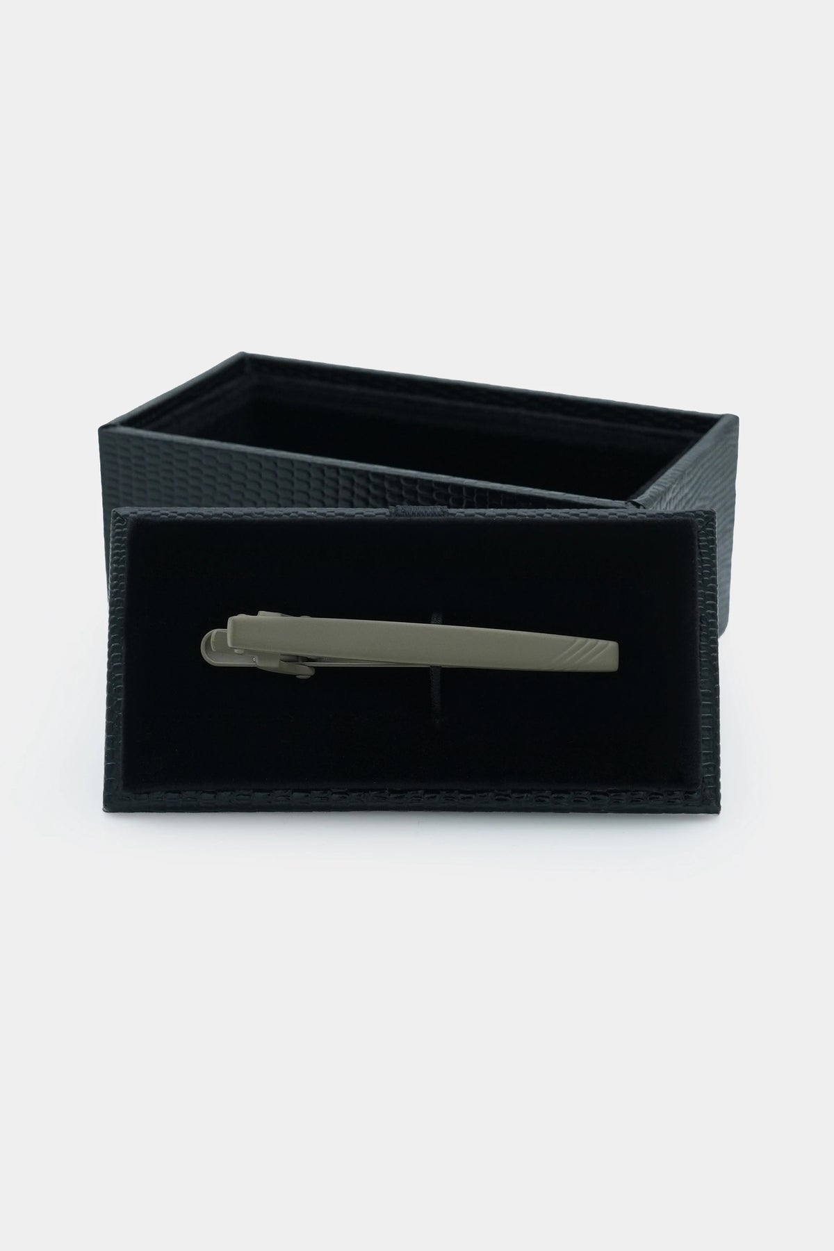 Charcoal tie pin in black textured gift box, bar visible