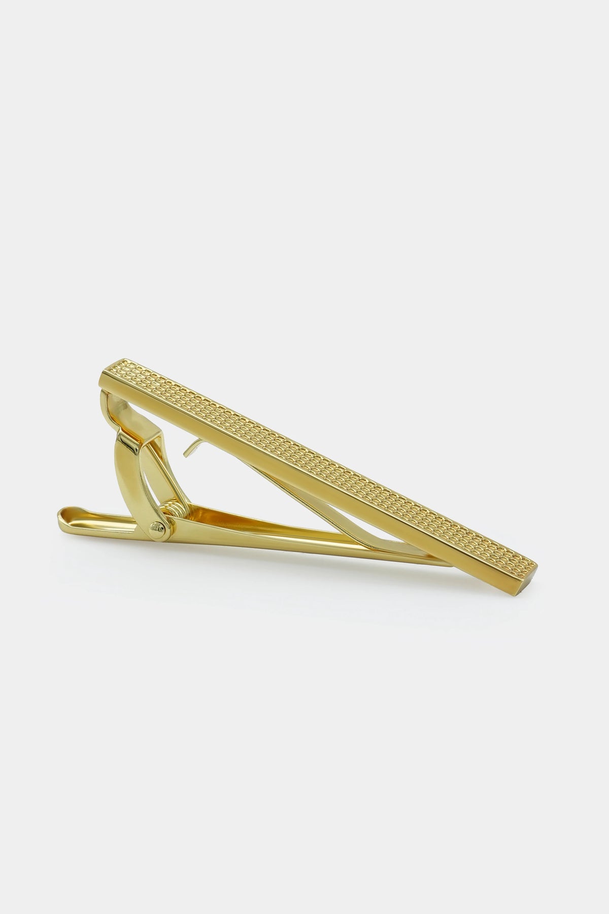 Gold tie pin with textured bar and hinged clasp, angled view