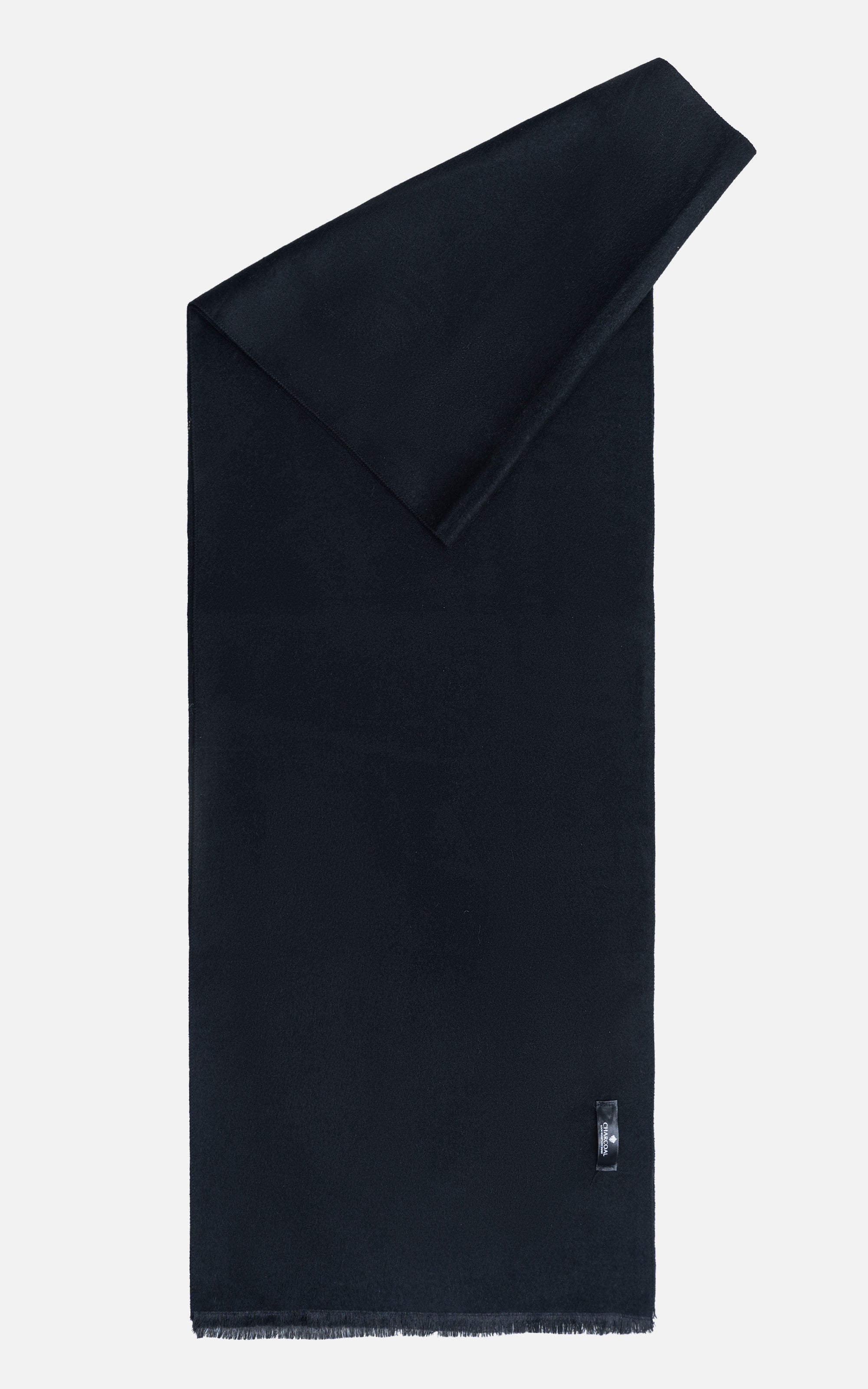 Dark scarf folded with angled end, fringed bottom edge, small logo tab