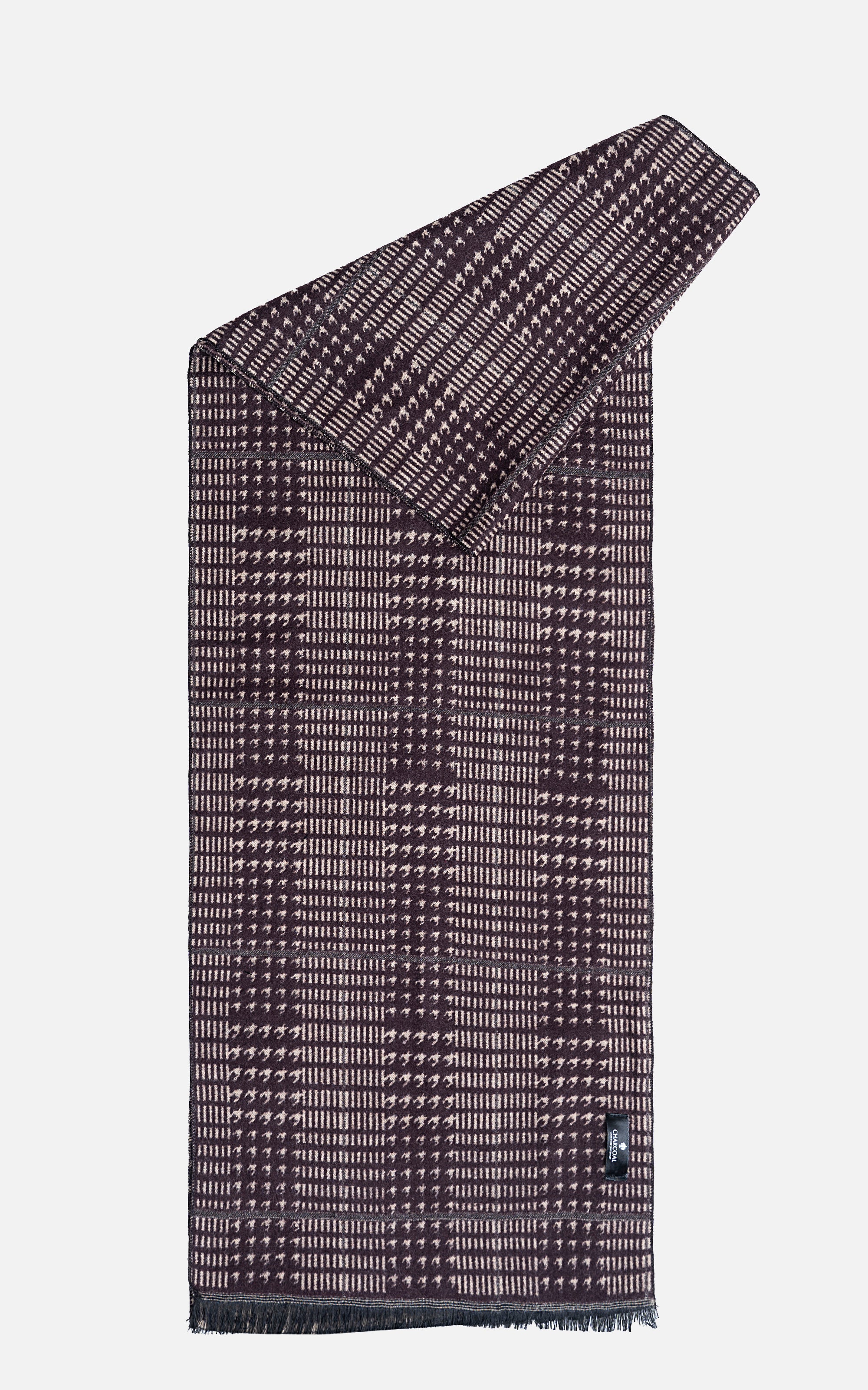 Dark patterned scarf with diagonal drape fold, check grid, tassel fringe ends