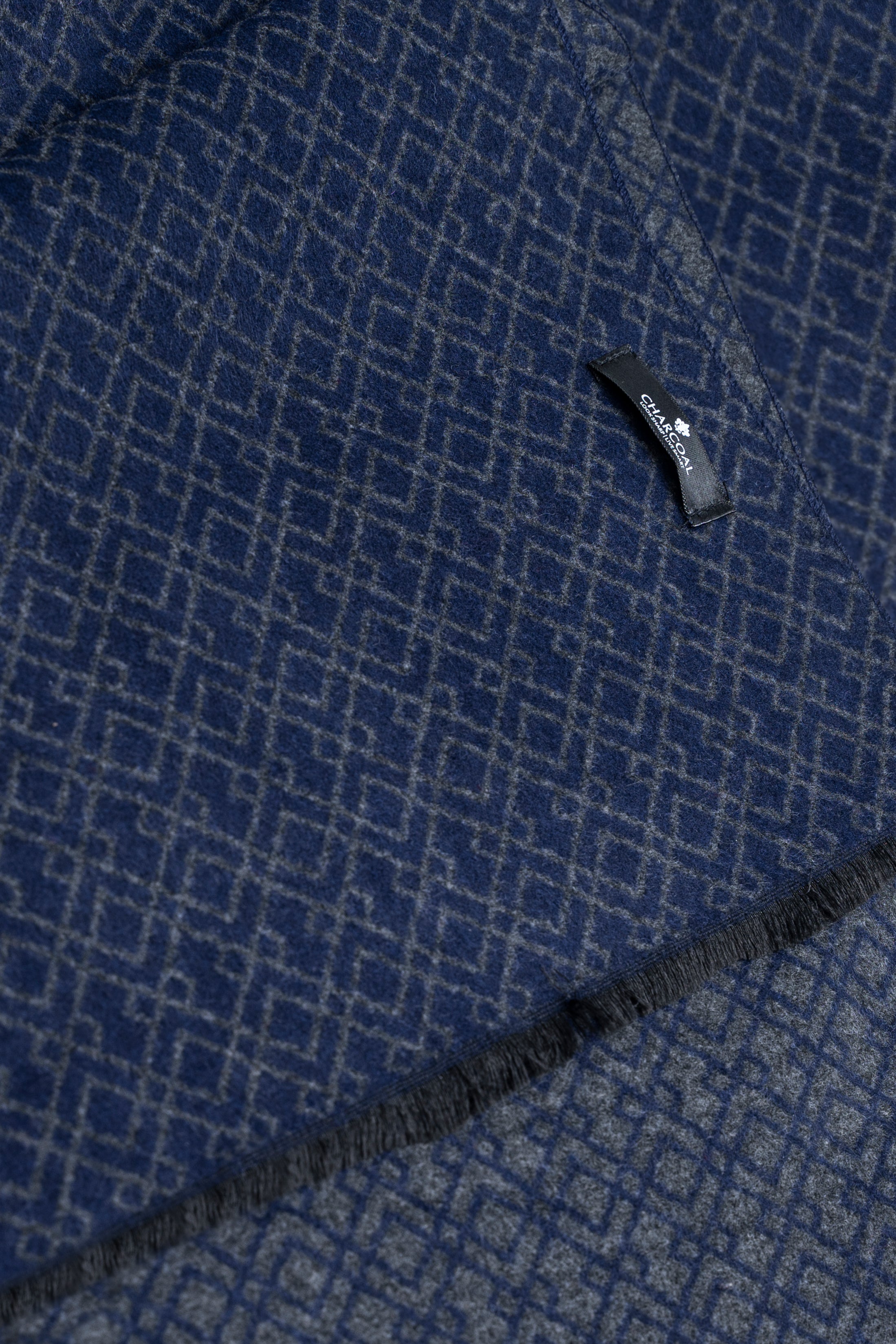 Navy-blue scarf with close-up geometric weave and stitched corner edge