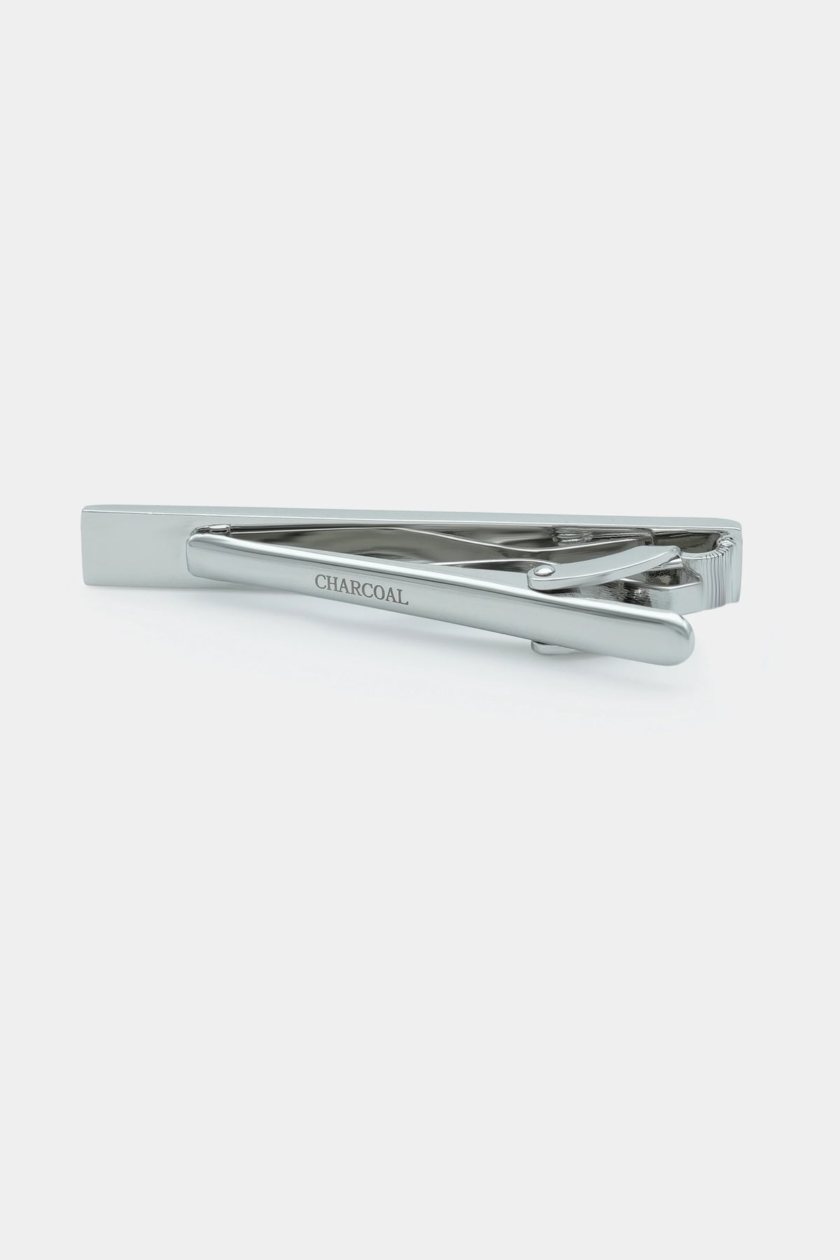 Silver tie pin with clasp and yellow rhinestone bar; CHARCOAL engraving