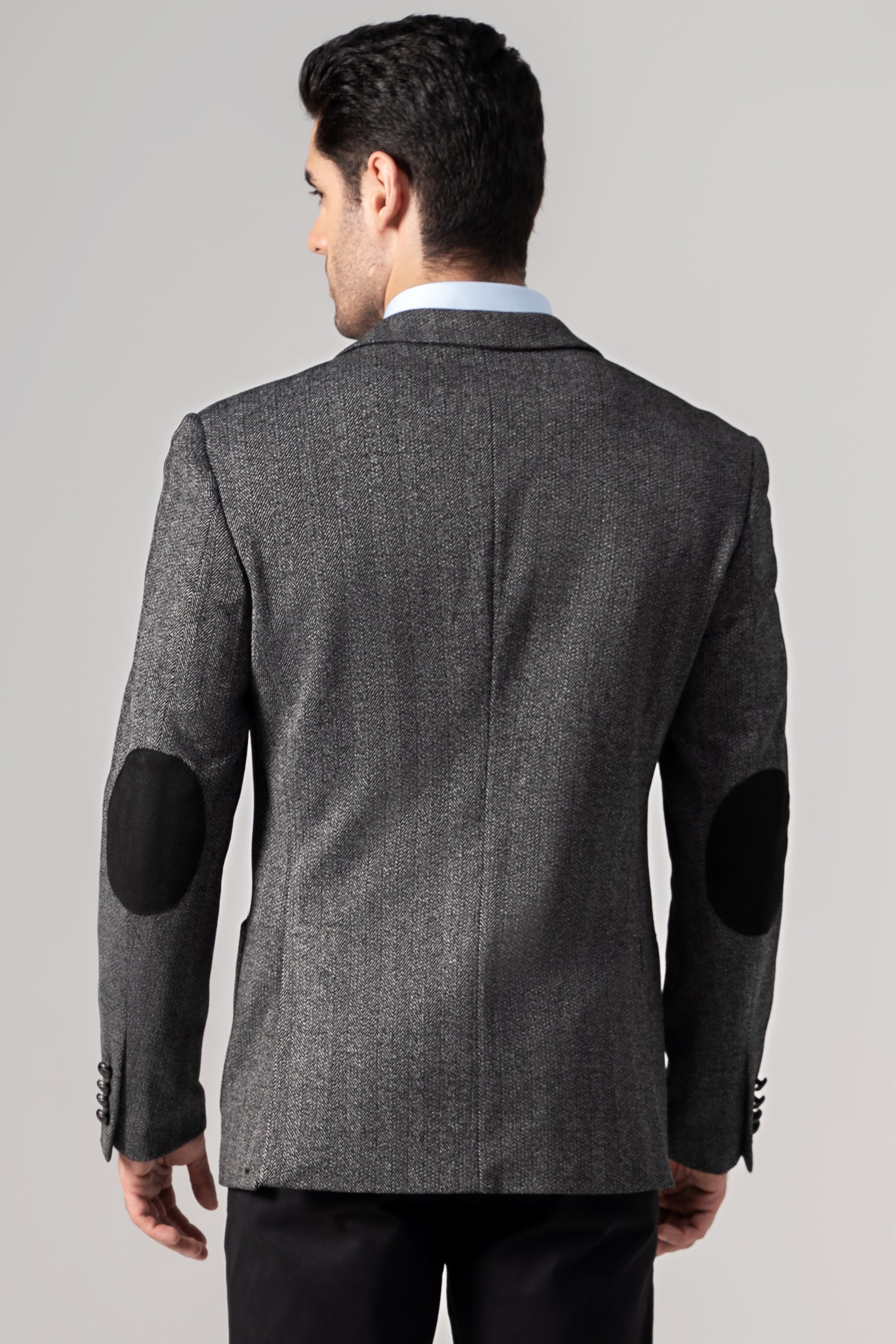 Casual coat back view with dark elbow patches and textured herringbone fabric