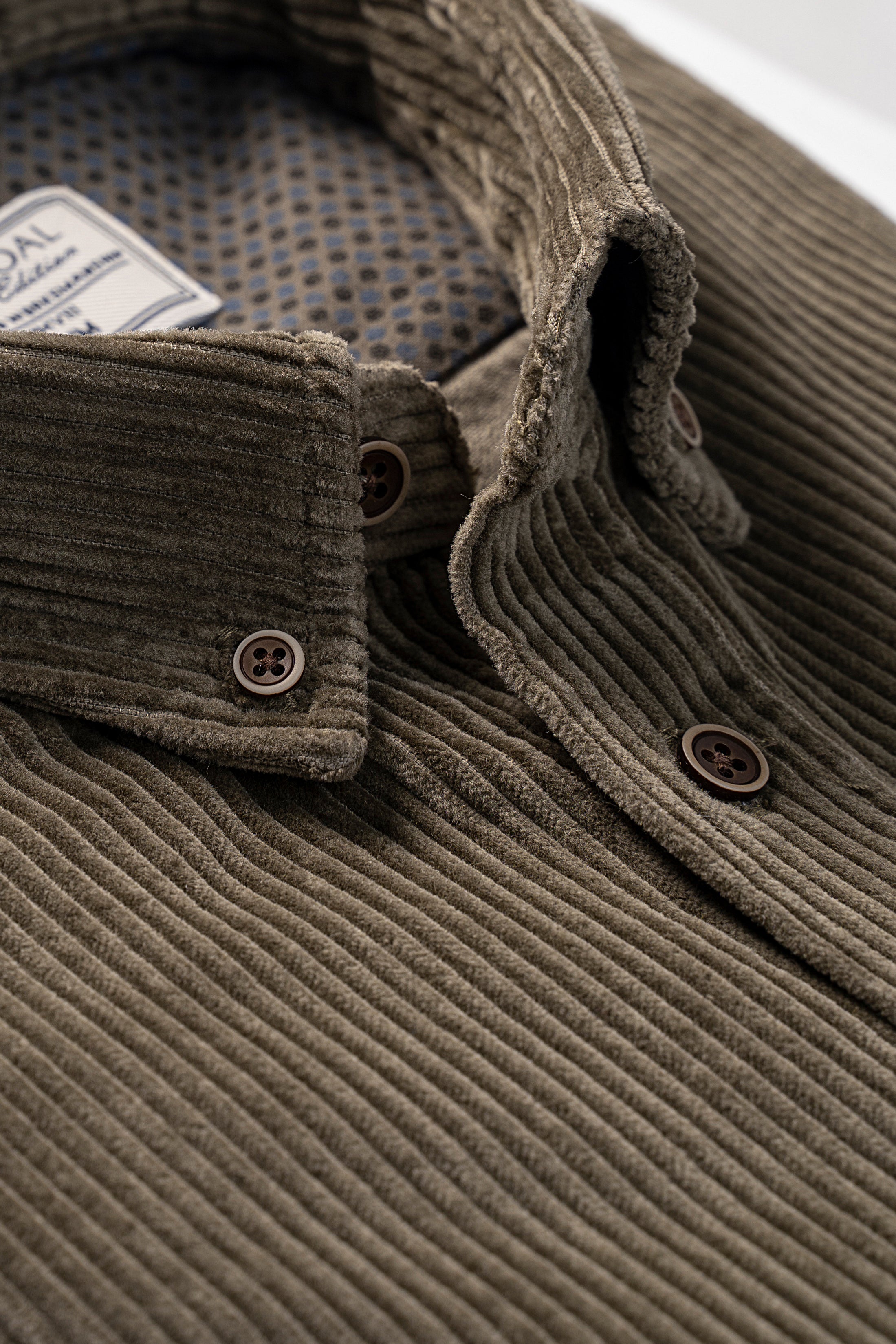 Olive corduroy shirt front placket with two button closures and collar