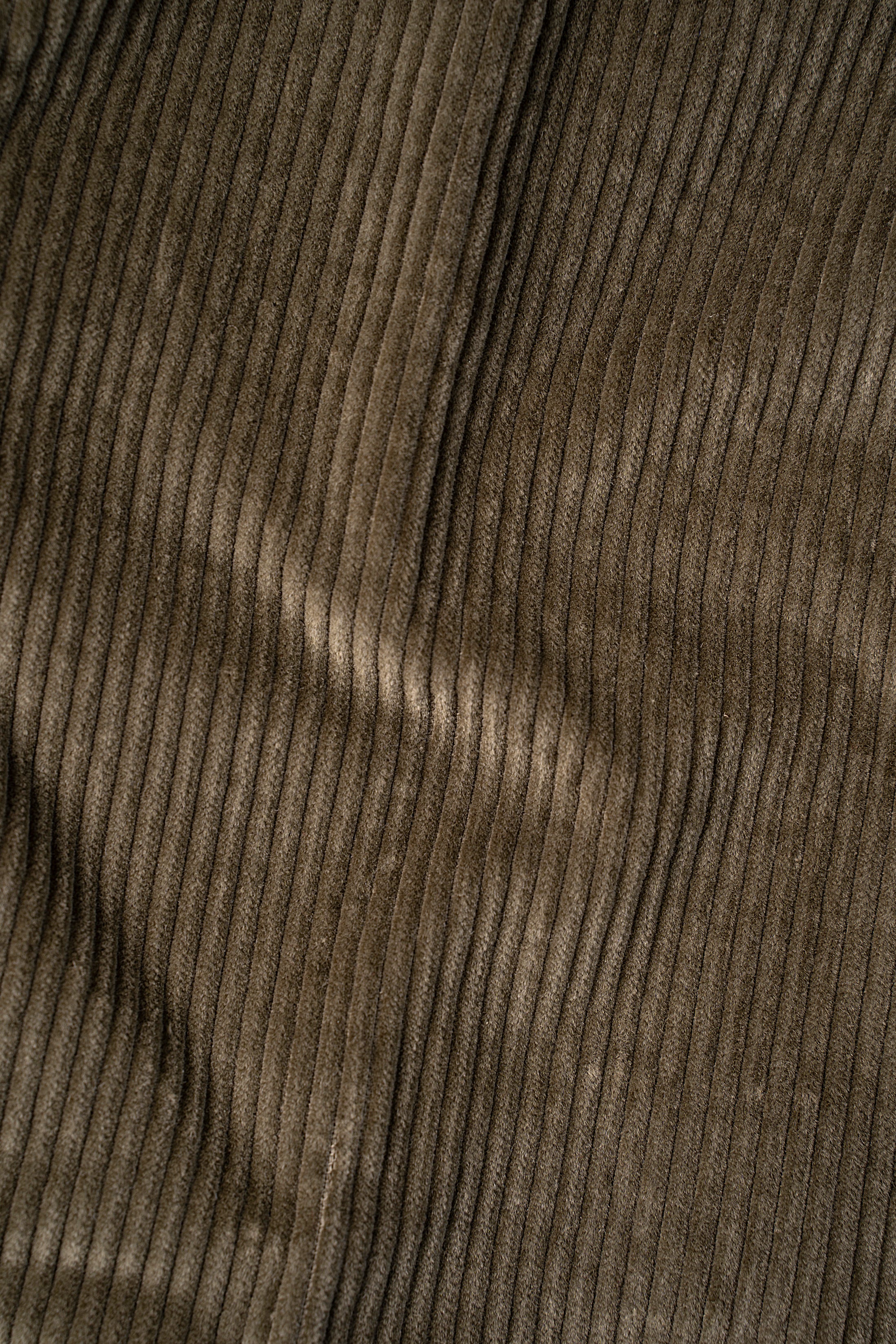 Olive corduroy fabric texture, fine vertical ridges