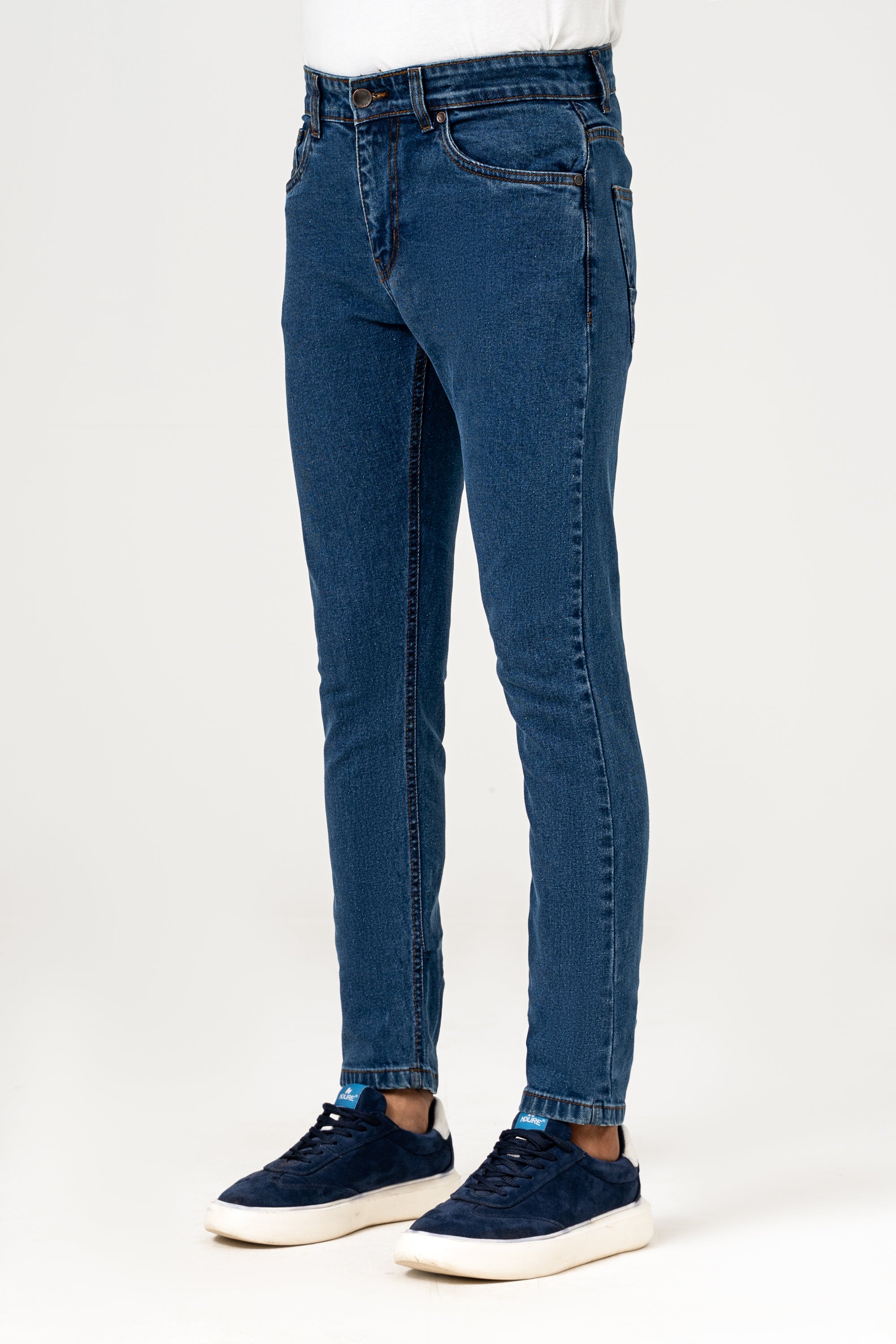 Mid blue slim-fit denim jeans with front pockets, button fly, and cuffed hem