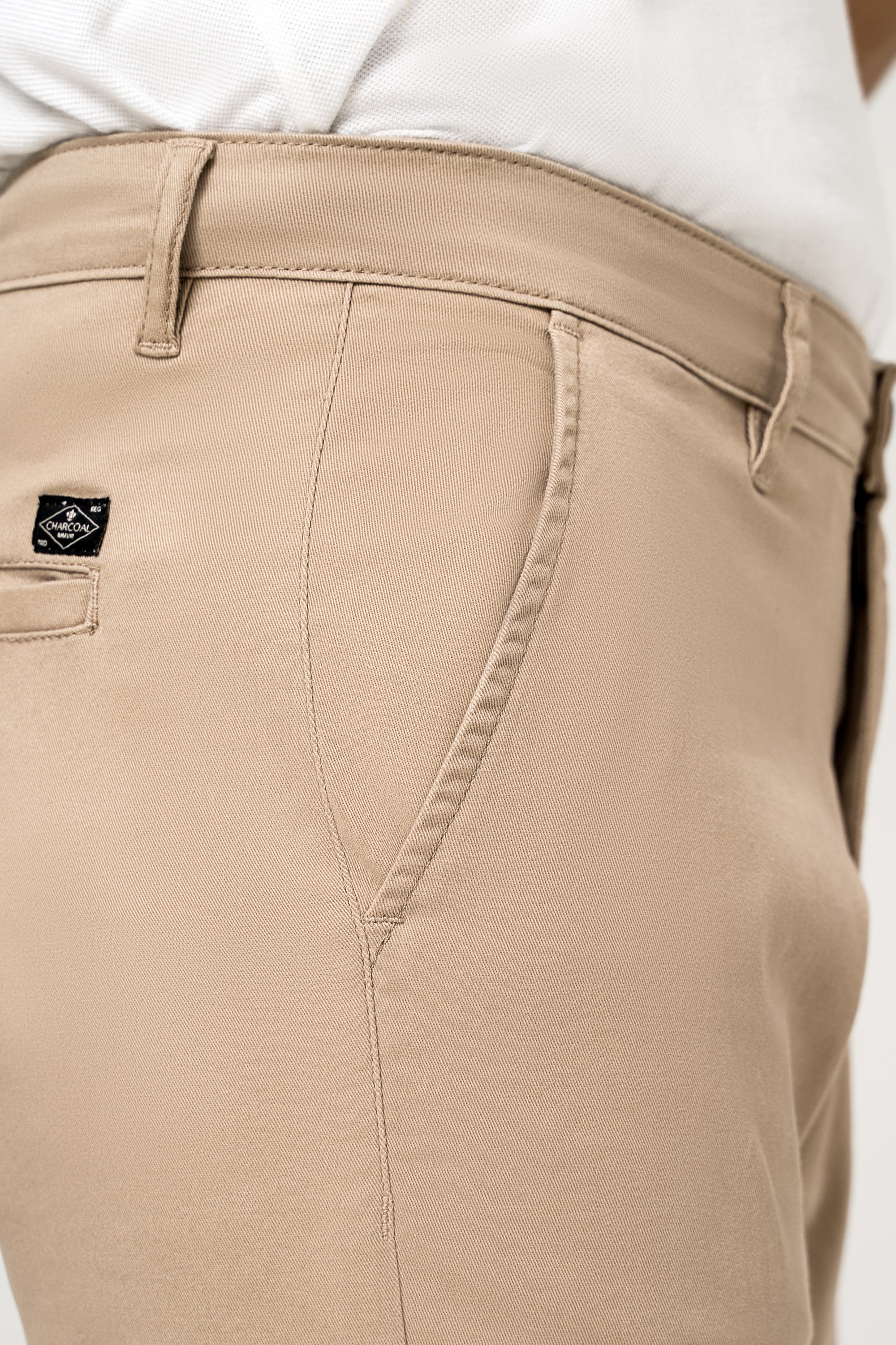 Beige casual pant pocket and waistband with small logo patch