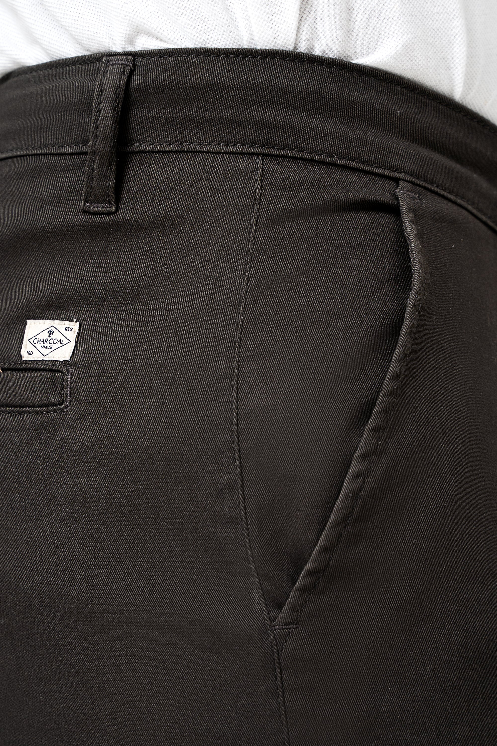 Dark olive casual pant pocket detail with stitched seam and brand tag