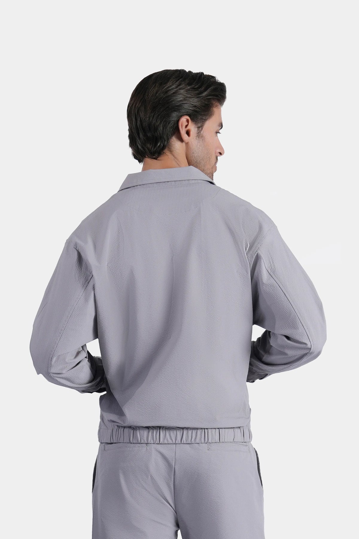 Light grey raglan jacket with elastic waist and cuffs, back view