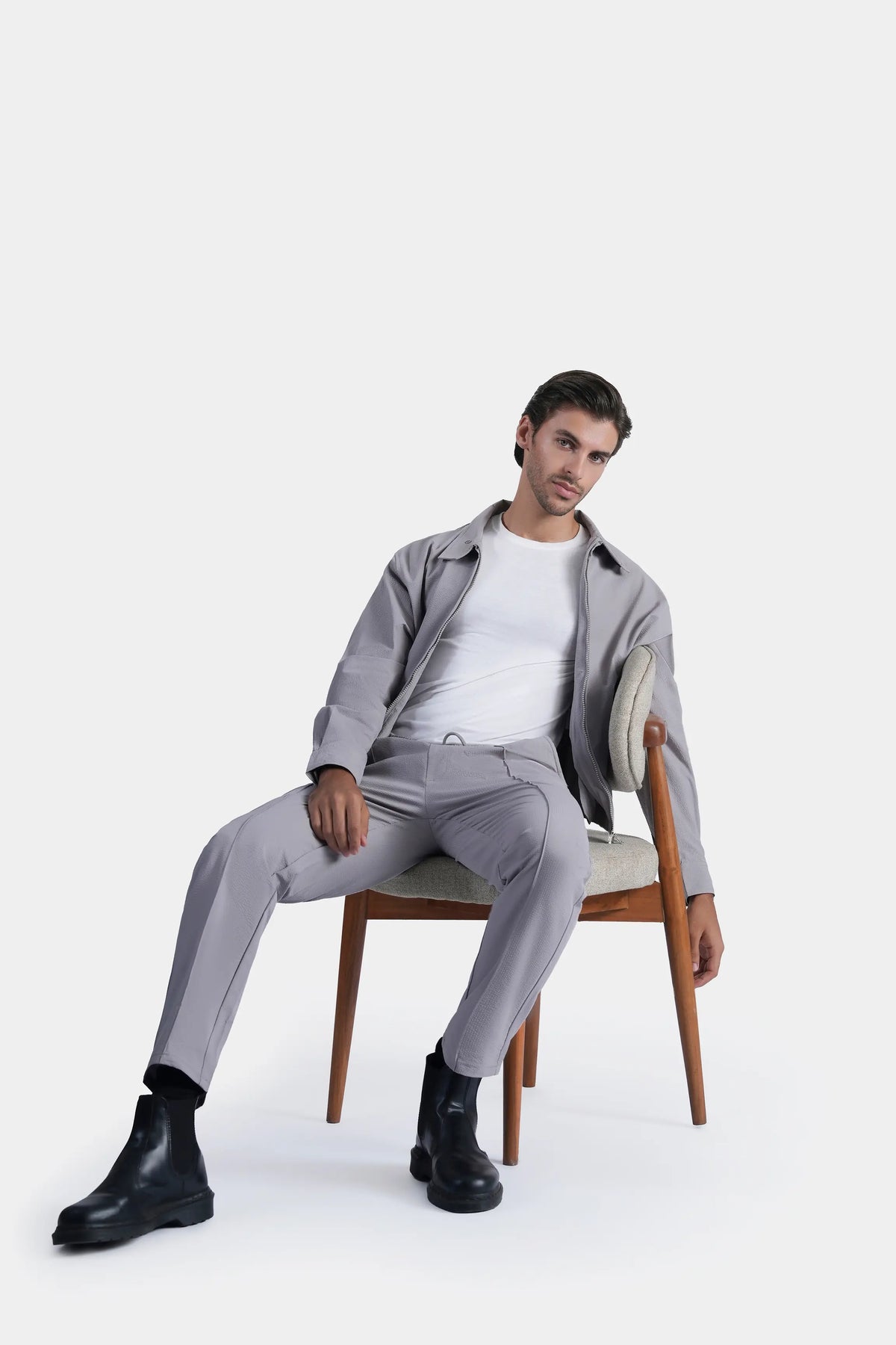 Light grey zip-up raglan jacket with stand collar, elastic hem, and side pockets