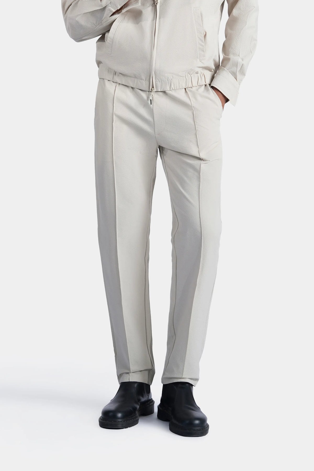 Beige seersucker trousers, vertical seams and relaxed straight fit