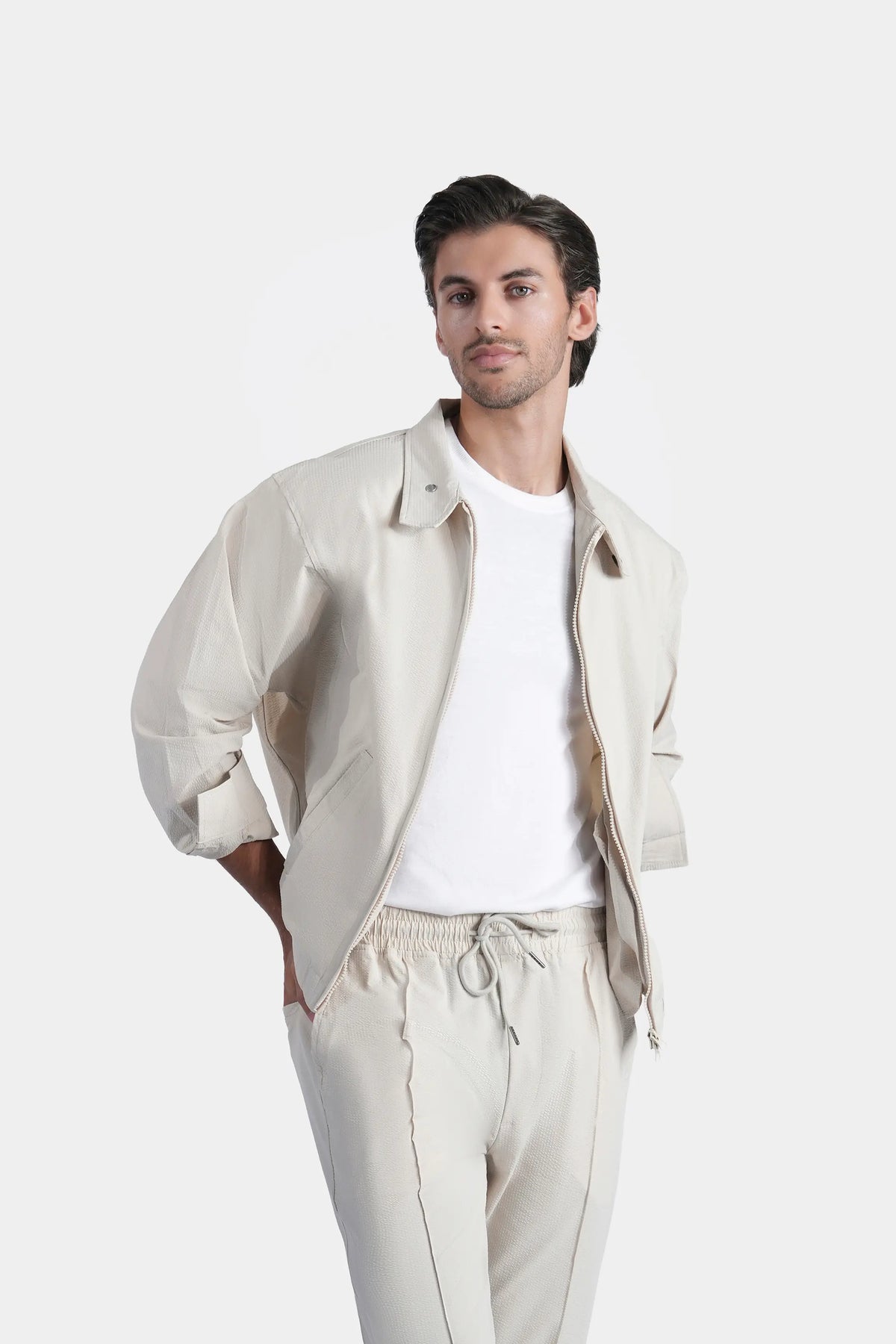 Beige seersucker raglan jacket, zip front, buttoned stand collar, front view