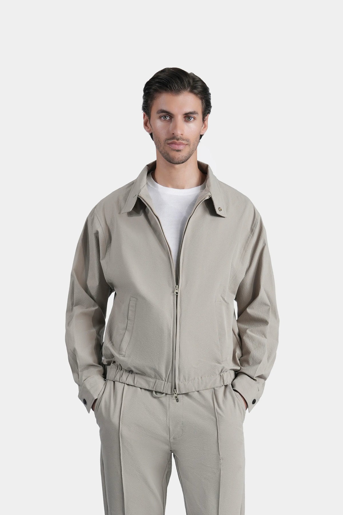Light seersucker raglan jacket with full zipper, stand collar, side pockets.