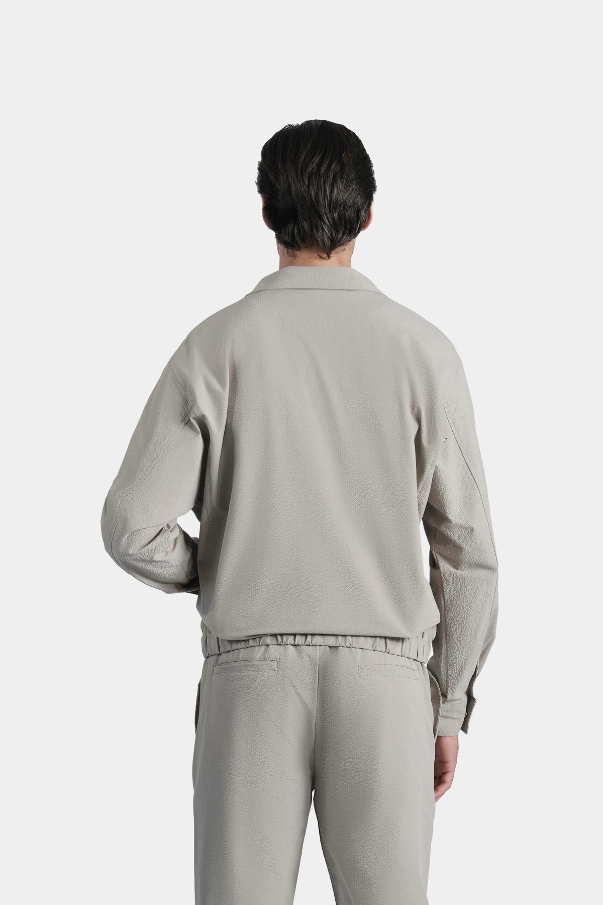 Men's sage seersucker jacket, back view with relaxed fit and elastic hem