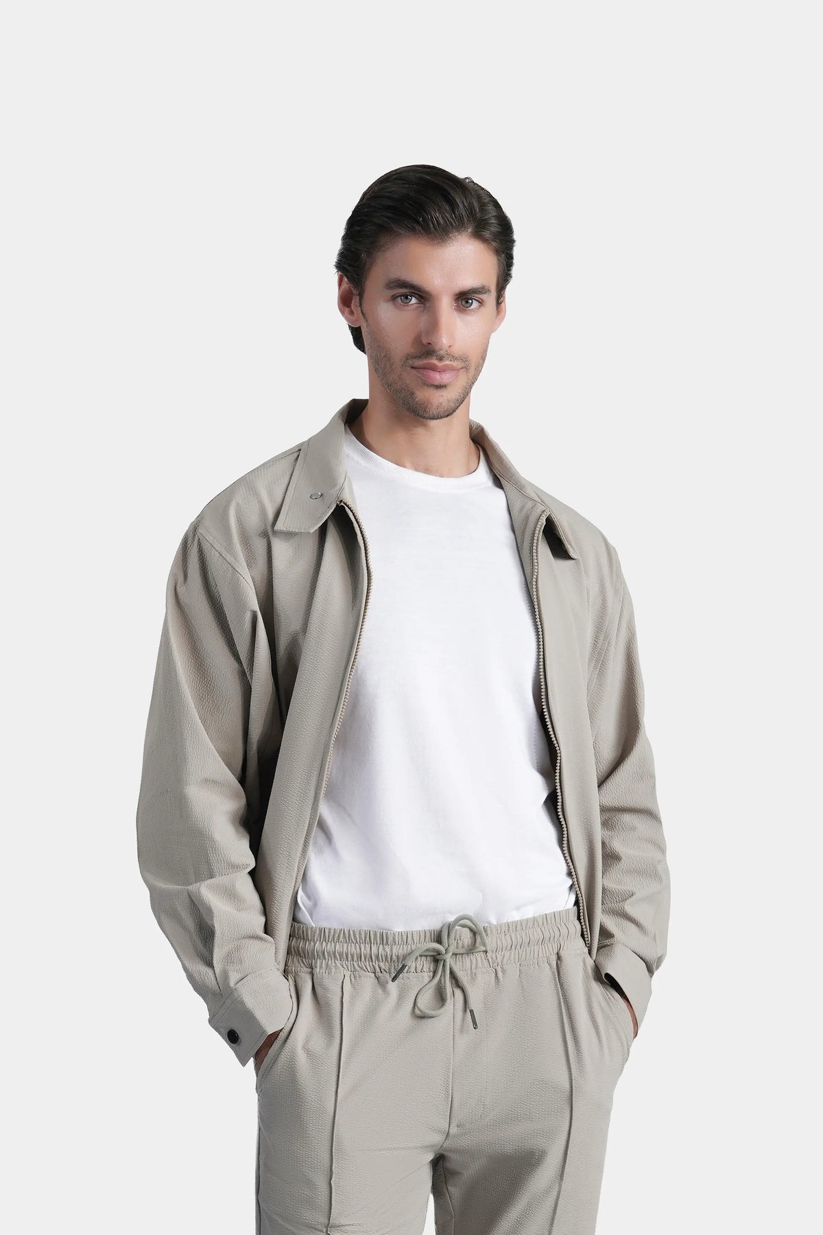 Men's sage seersucker jacket with stand collar, zipper front, and drawstring waist