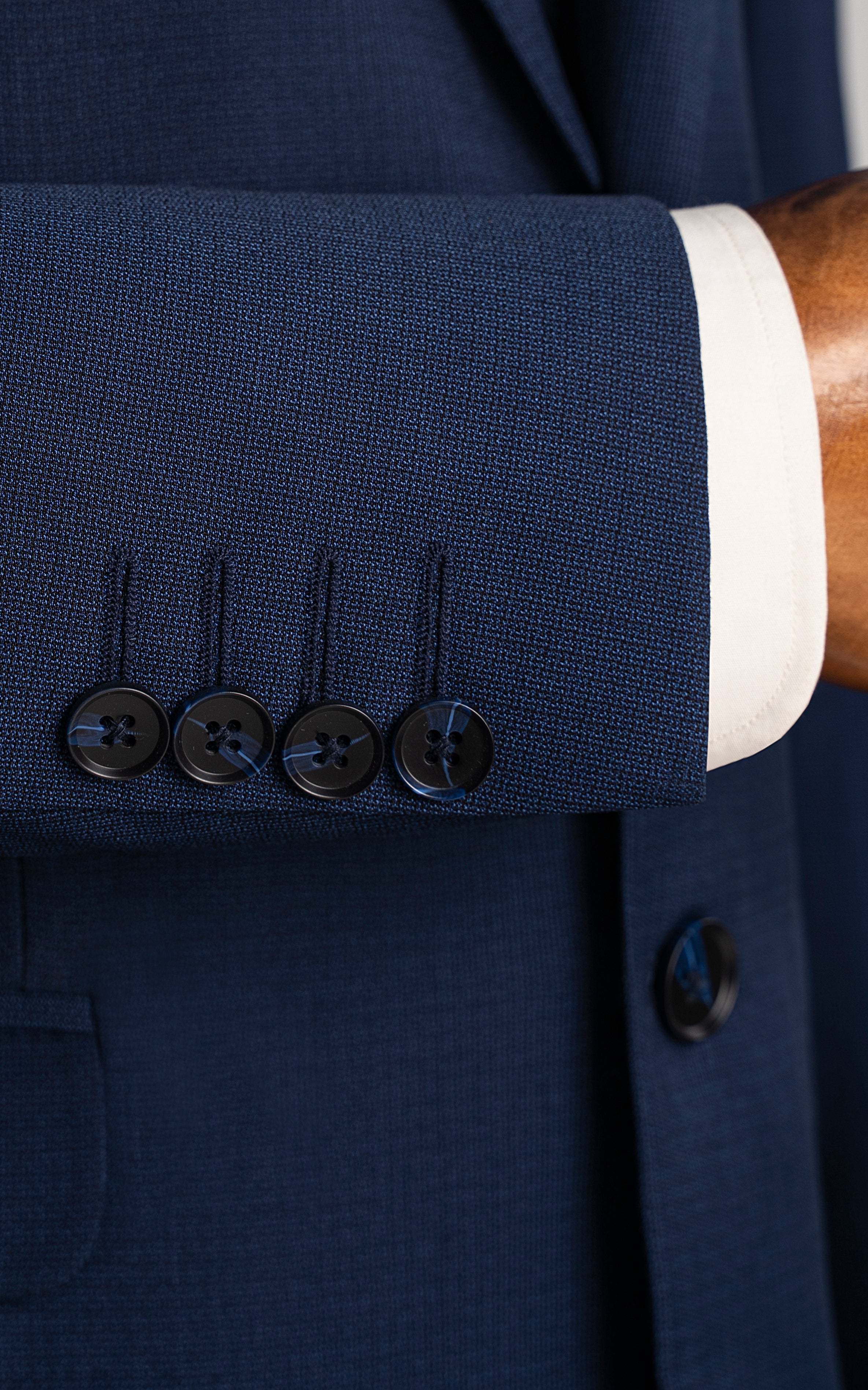 Blue suit jacket cuff with four buttons and decorative buttonhole stitching