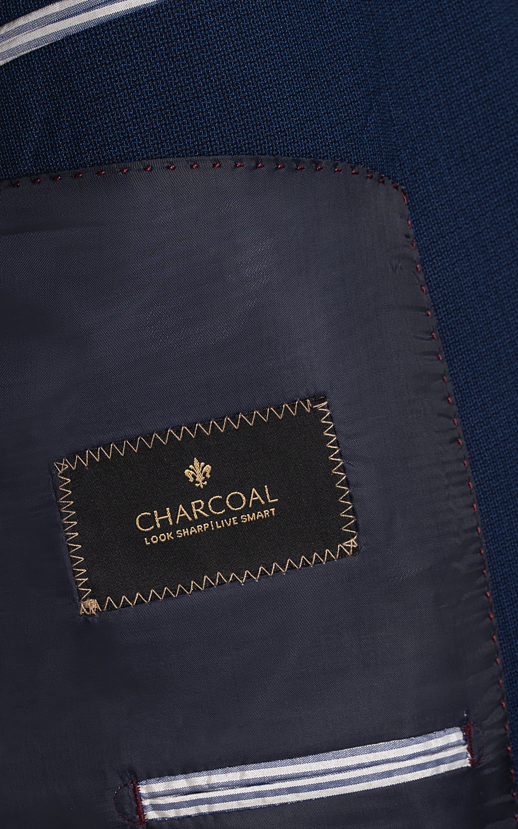 Suit lining label reading CHARCOAL, with stitched inner trim and edge