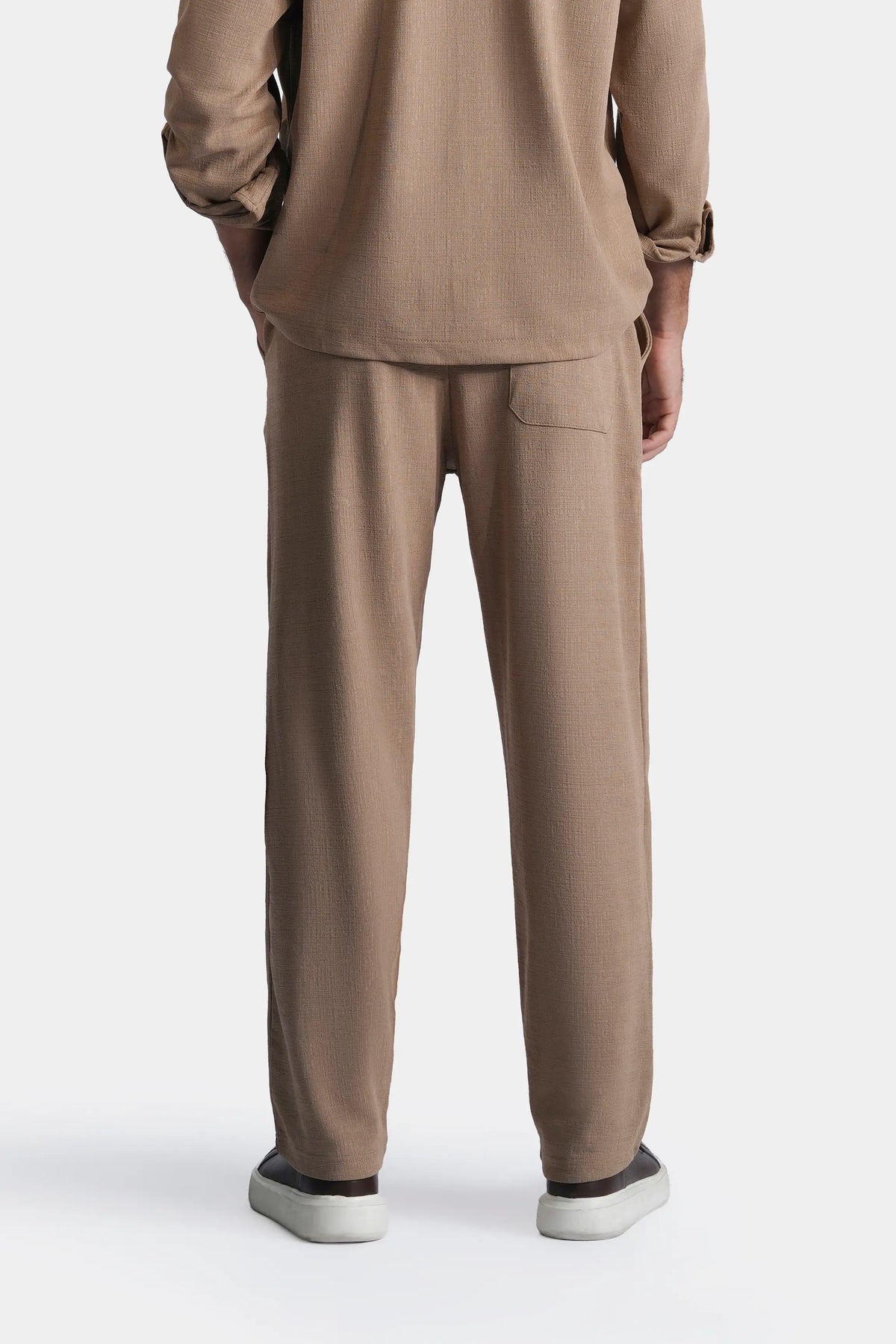 Khaki loose-fit trousers with back pockets and waistband, rear view