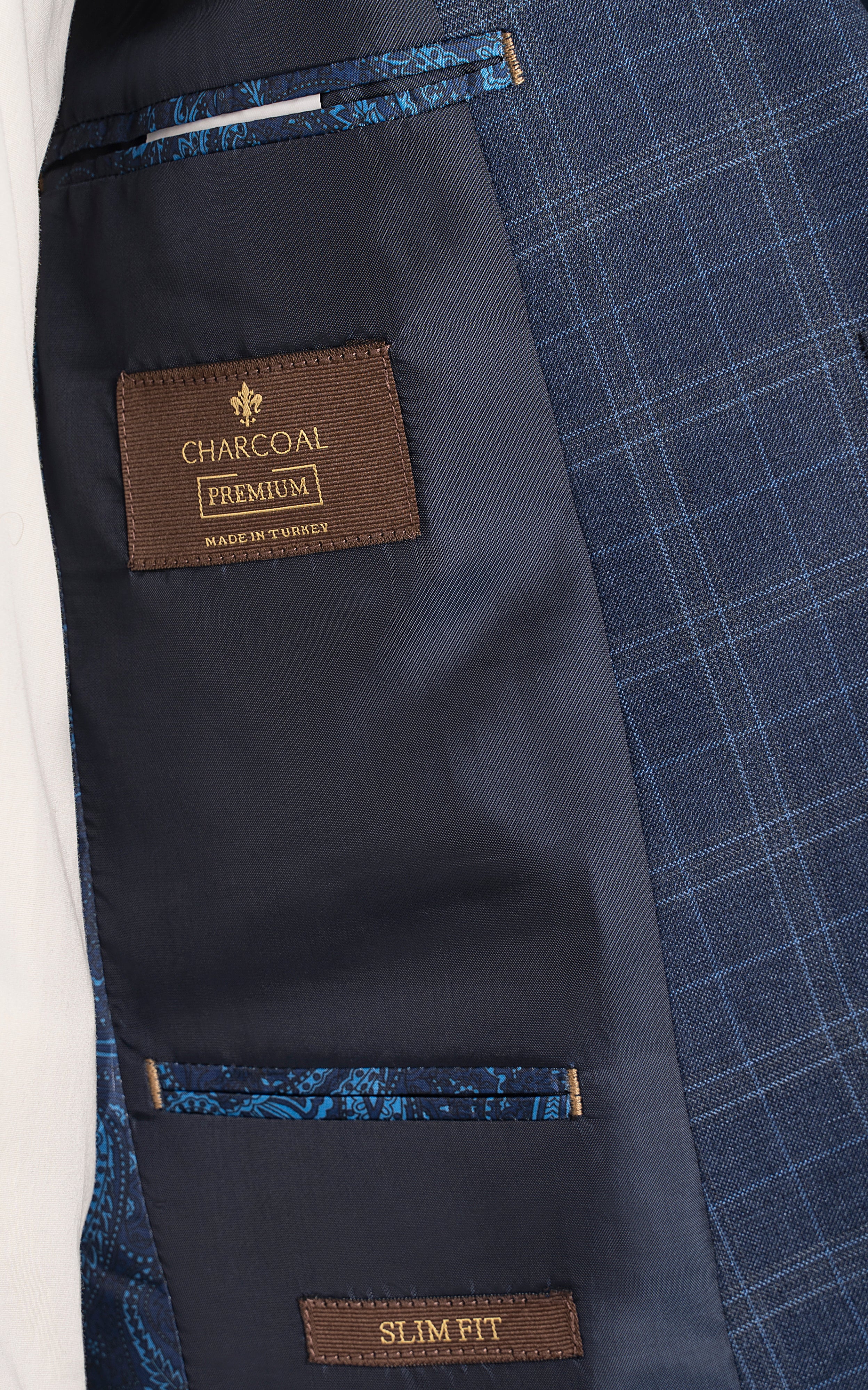 Navy blue suit interior with CHARCOAL Premium label and slim fit tag