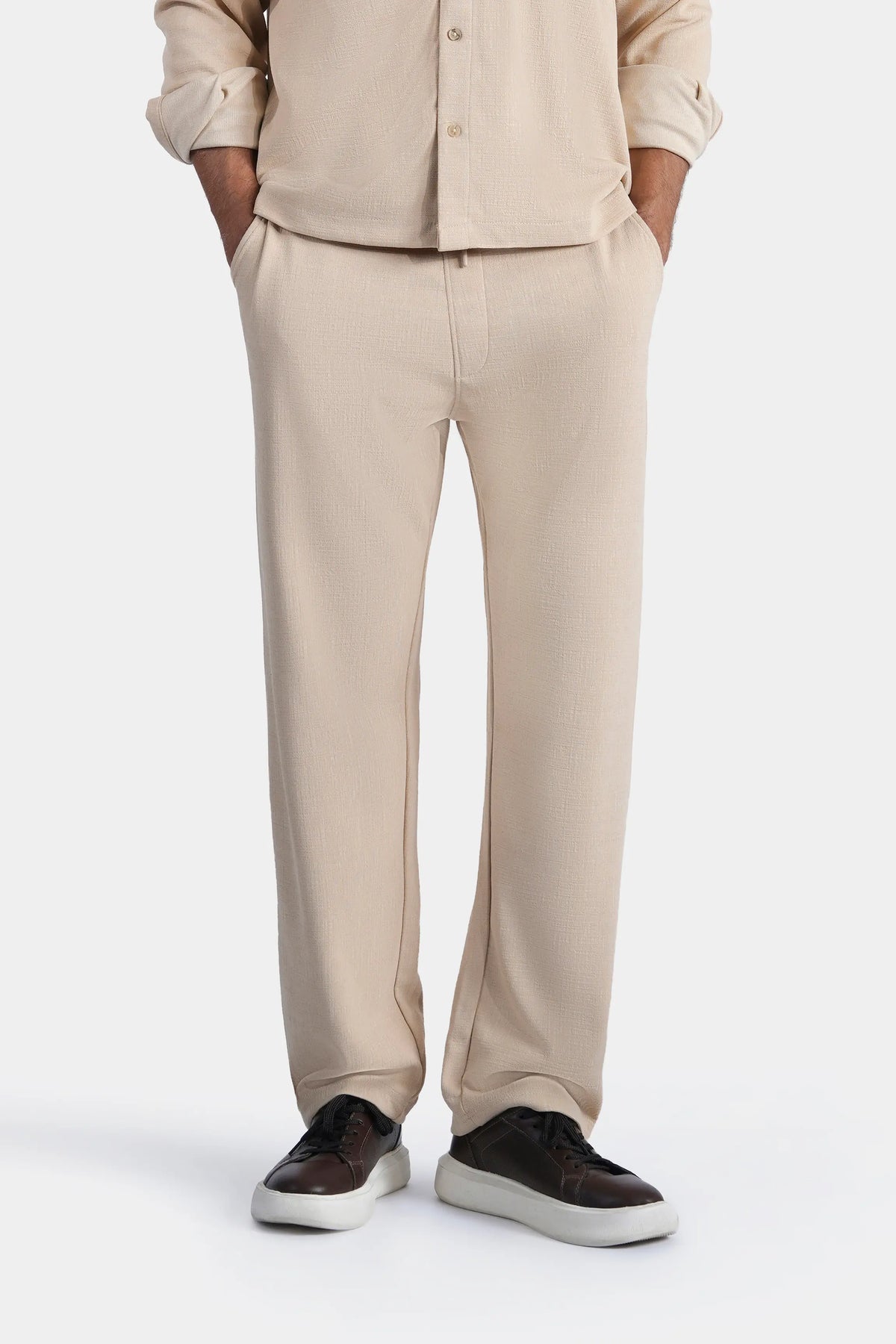 Beige loose-fit trousers with straight legs and center-front seam