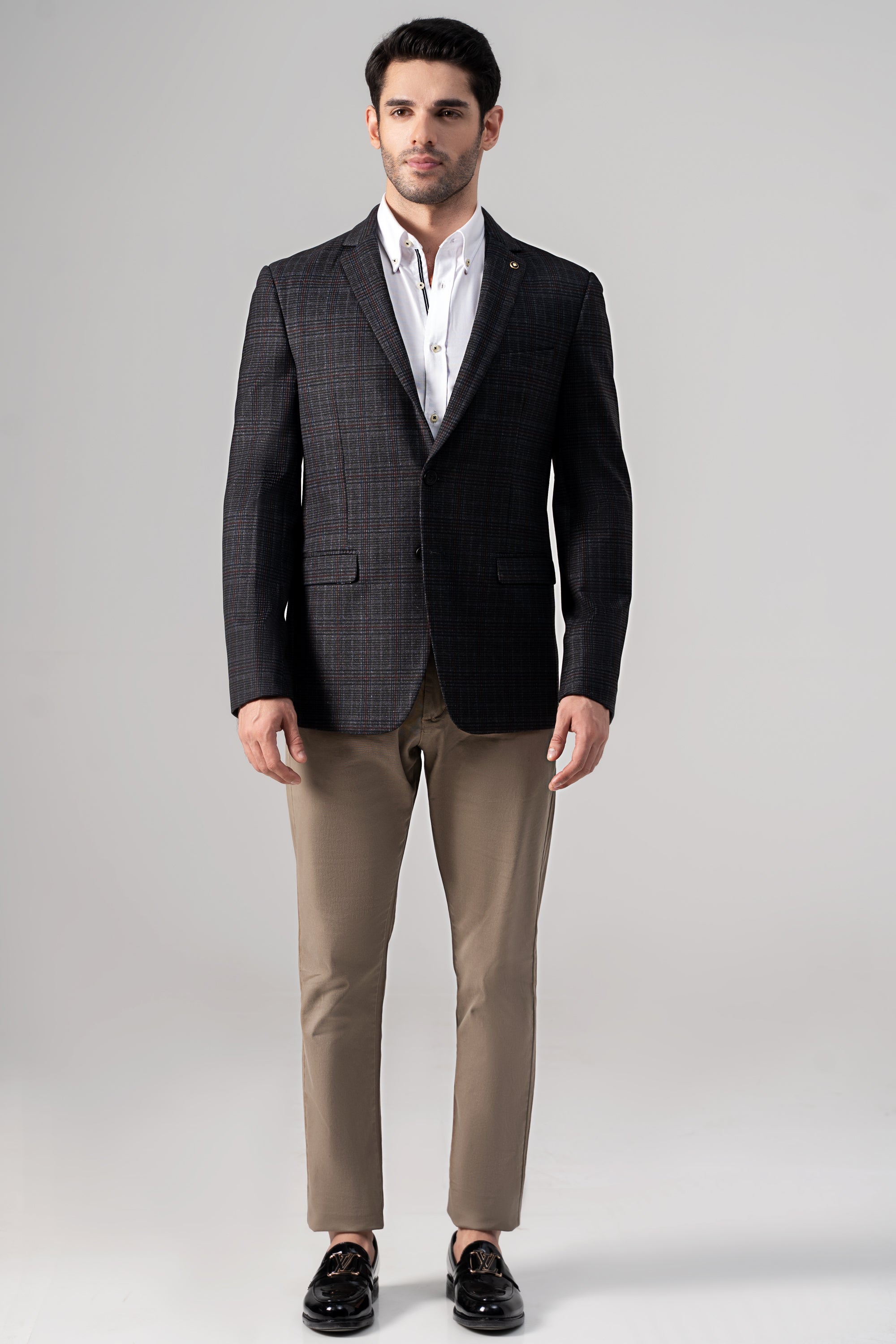 Grey check casual coat with notch lapels over white shirt; single-breasted look.