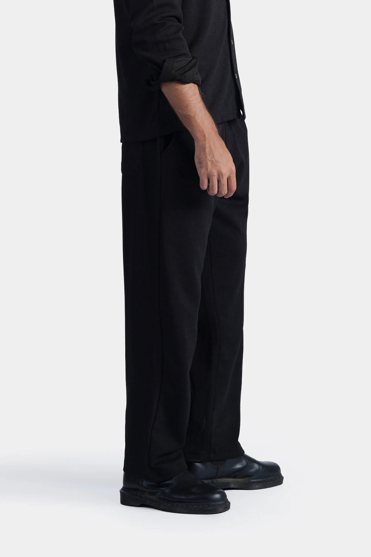 Loose-fit black trousers with front pleat detail and wide straight leg