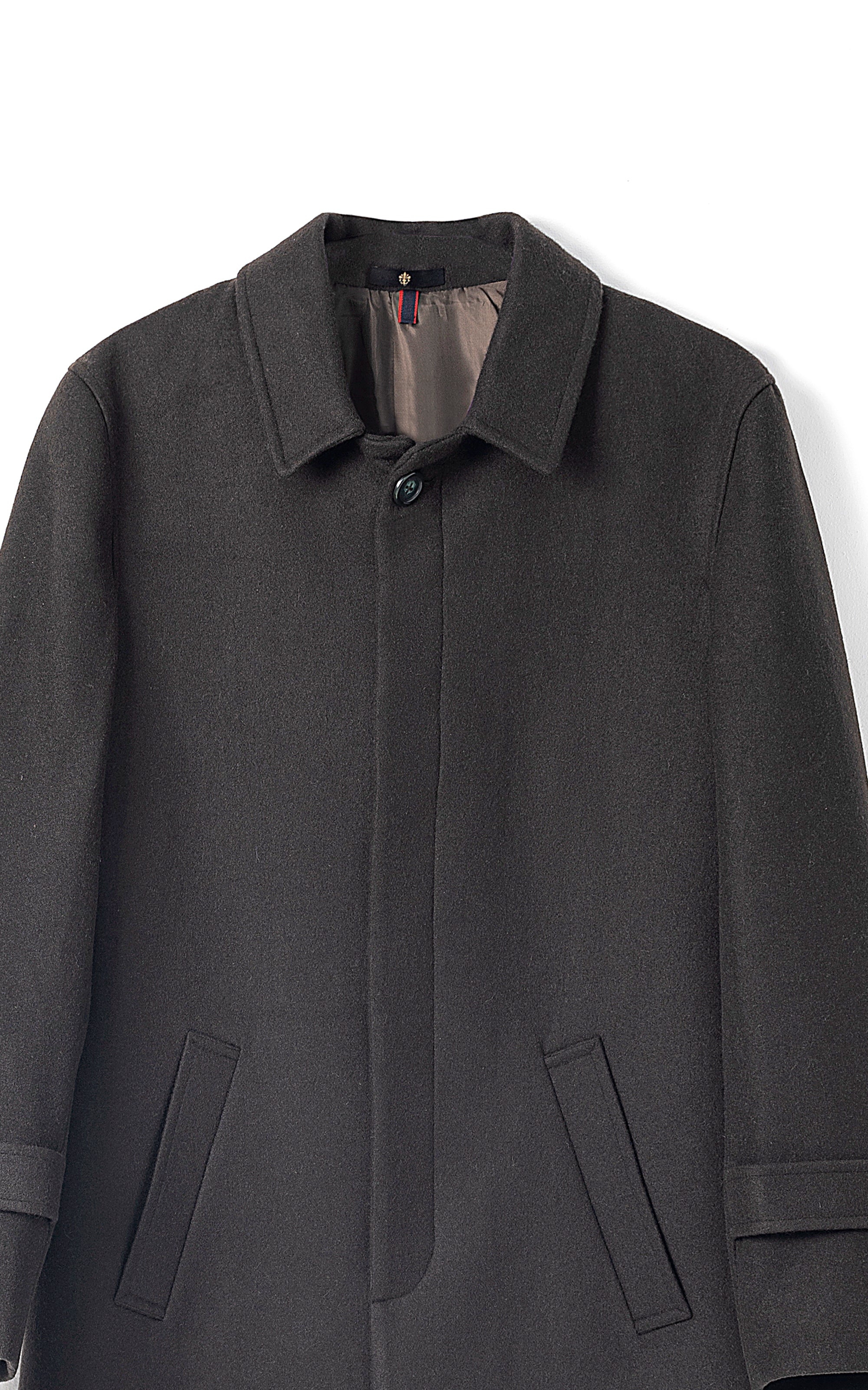 Long coat in deep olive, close-up button-front, notched collar, flap pockets, sleeve tabs