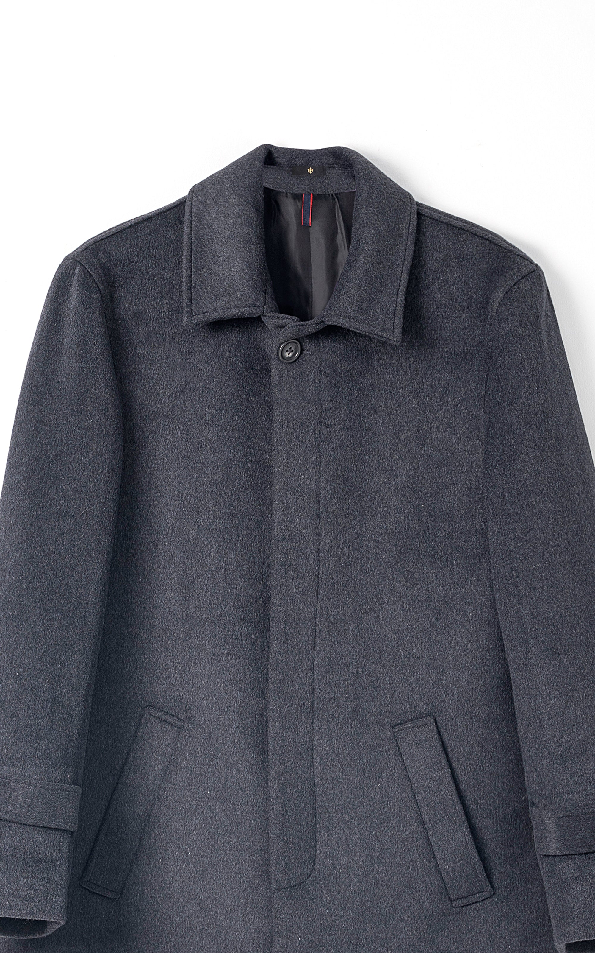 Charcoal long coat with notched lapel, button front, and flap pockets