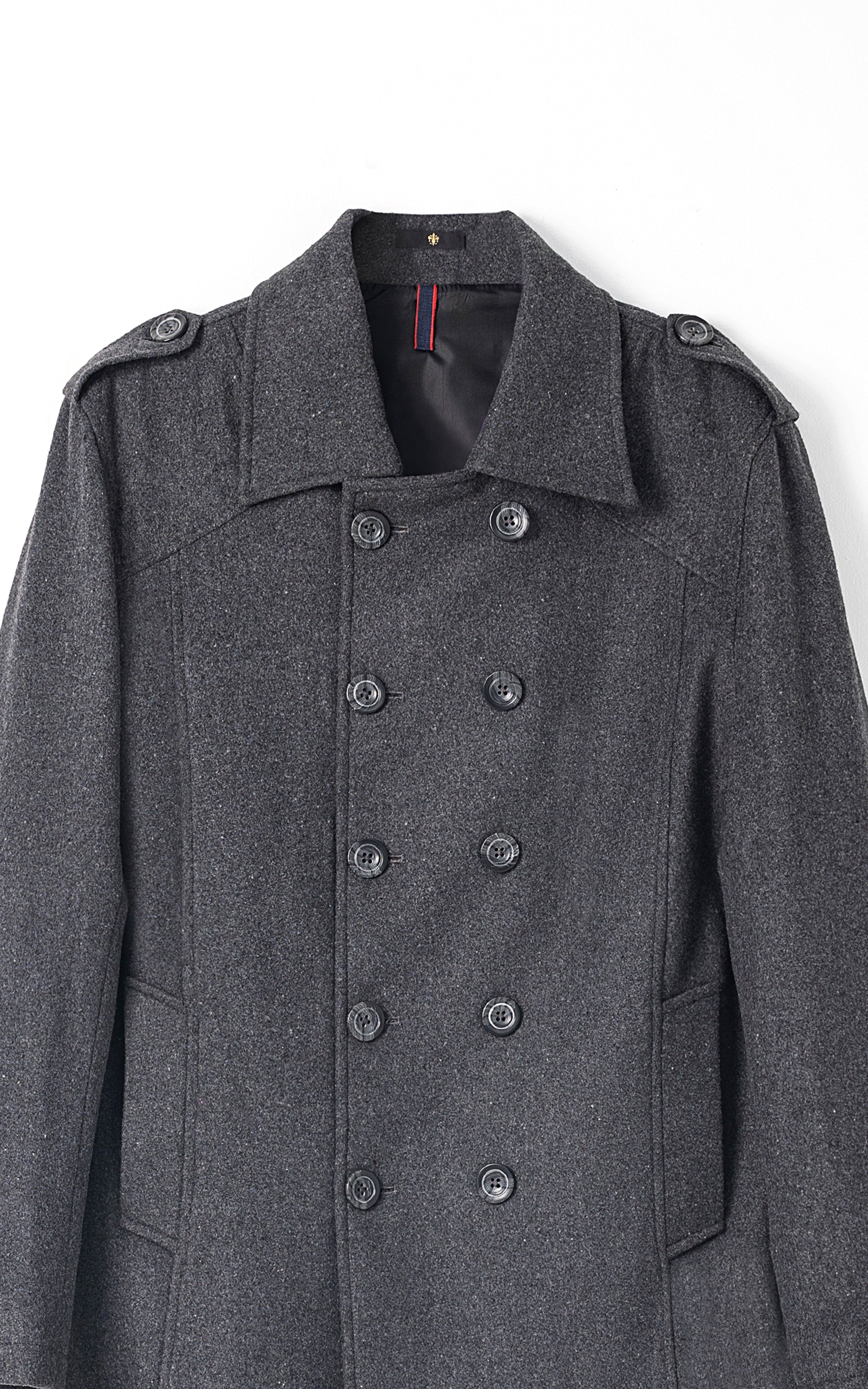 Dark gray double-breasted long coat detail view with large buttons and shoulder tabs
